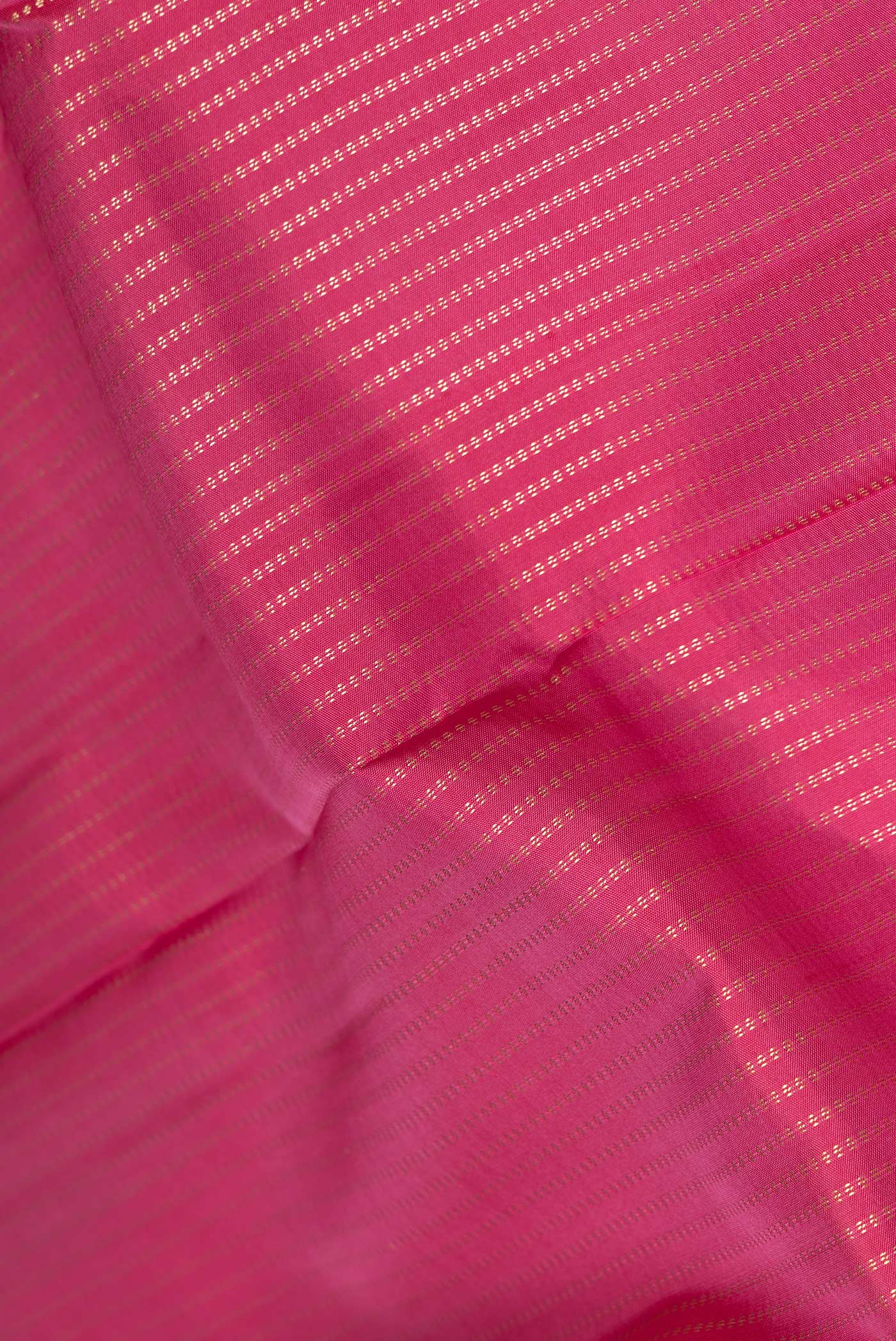 Close up of Pink Dual Tone Kanchipuram Silk Saree with Stripes on the body and Zari Border.  displaying folds