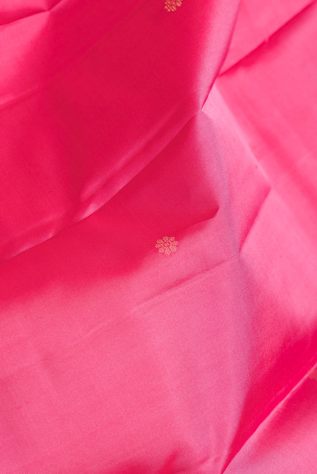 Close up of Pink Dual Tone Kanchipuram Silk Saree with Stripes on the body and Zari Border.  displaying folds