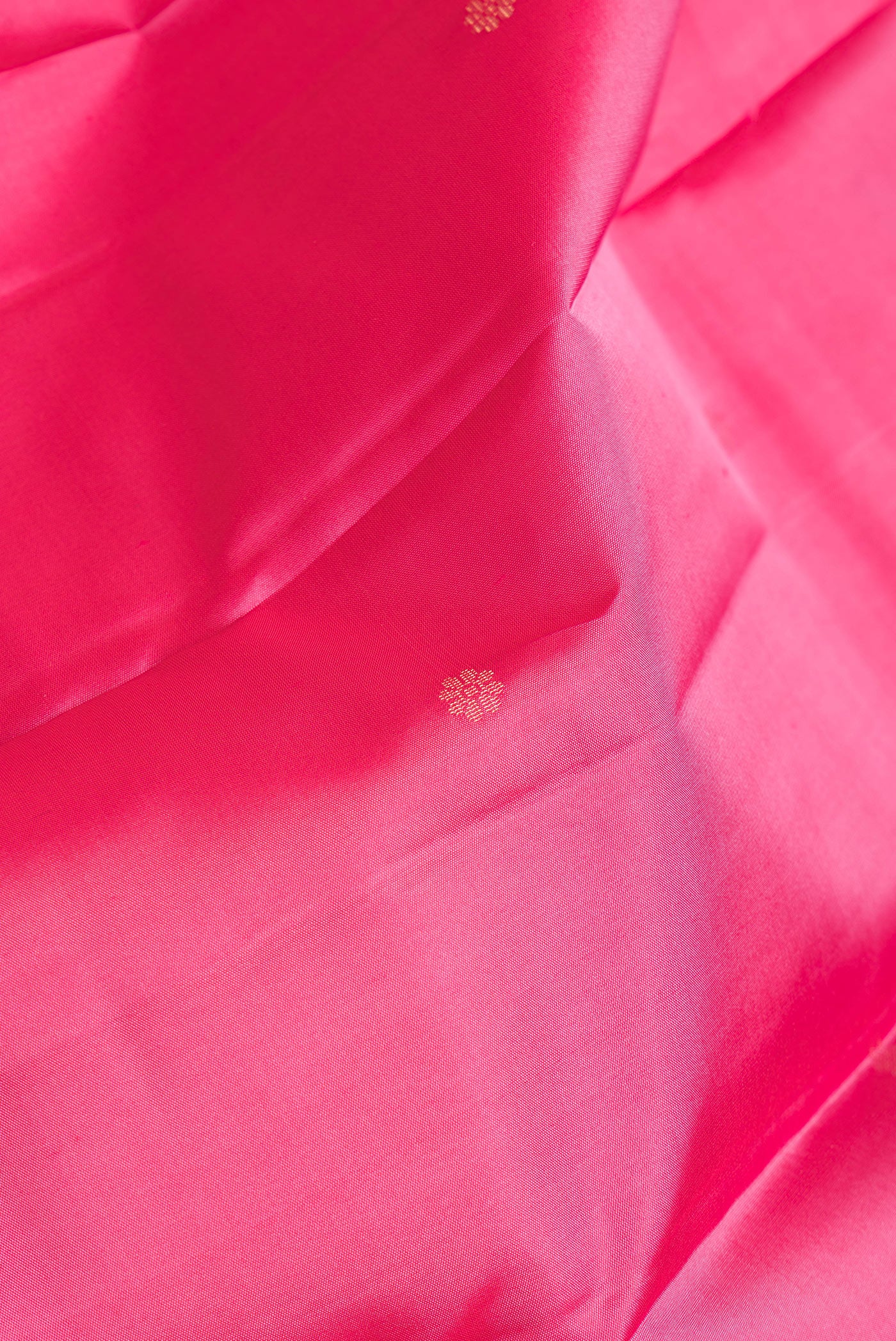 Close up of Pink Dual Tone Kanchipuram Silk Saree with Stripes on the body and Zari Border.  displaying folds