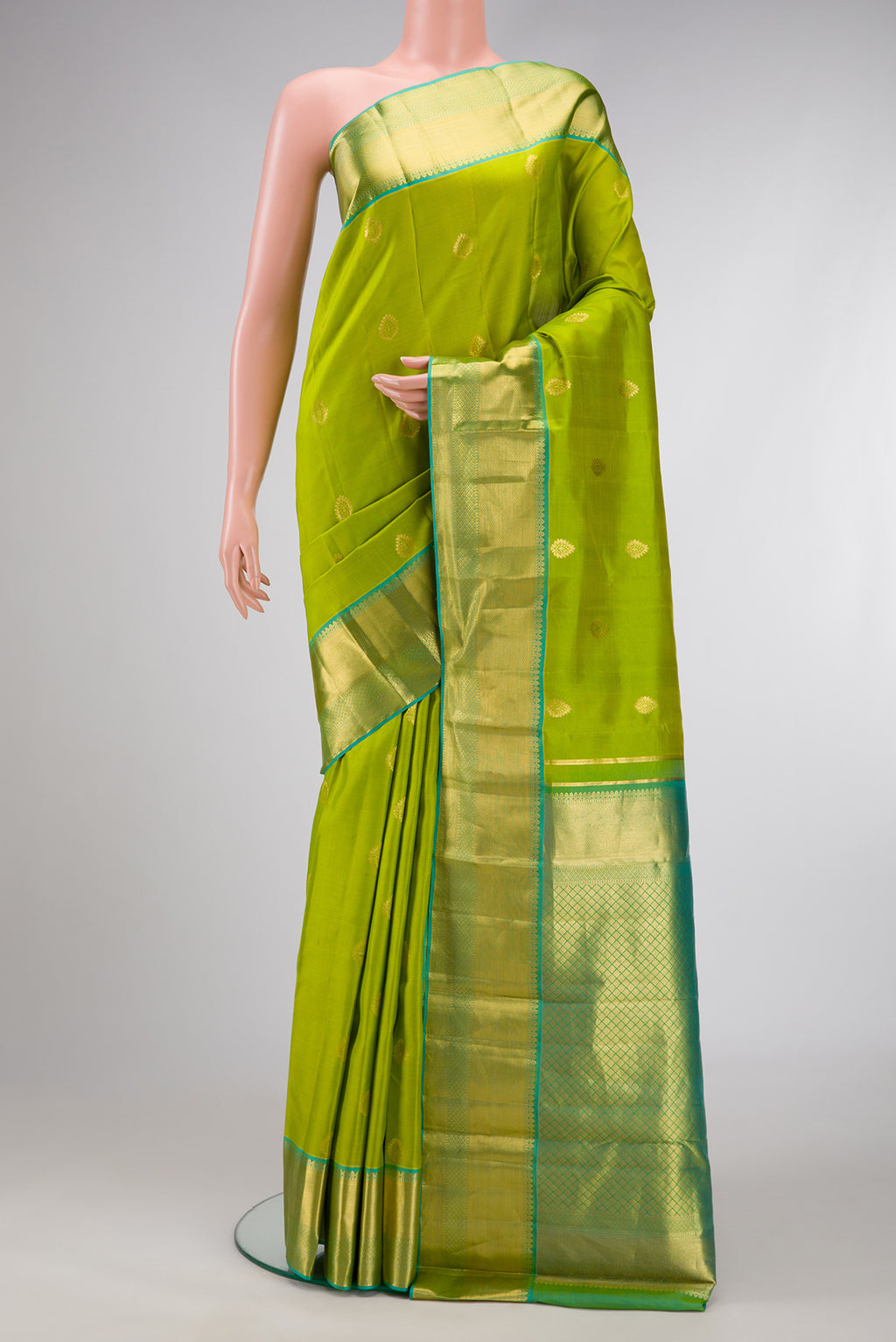 Parrot Green Dual Tone Kanjivaram Silk Saree with Zari Butta on the body and Zari Border.  displayed on a mannequin
