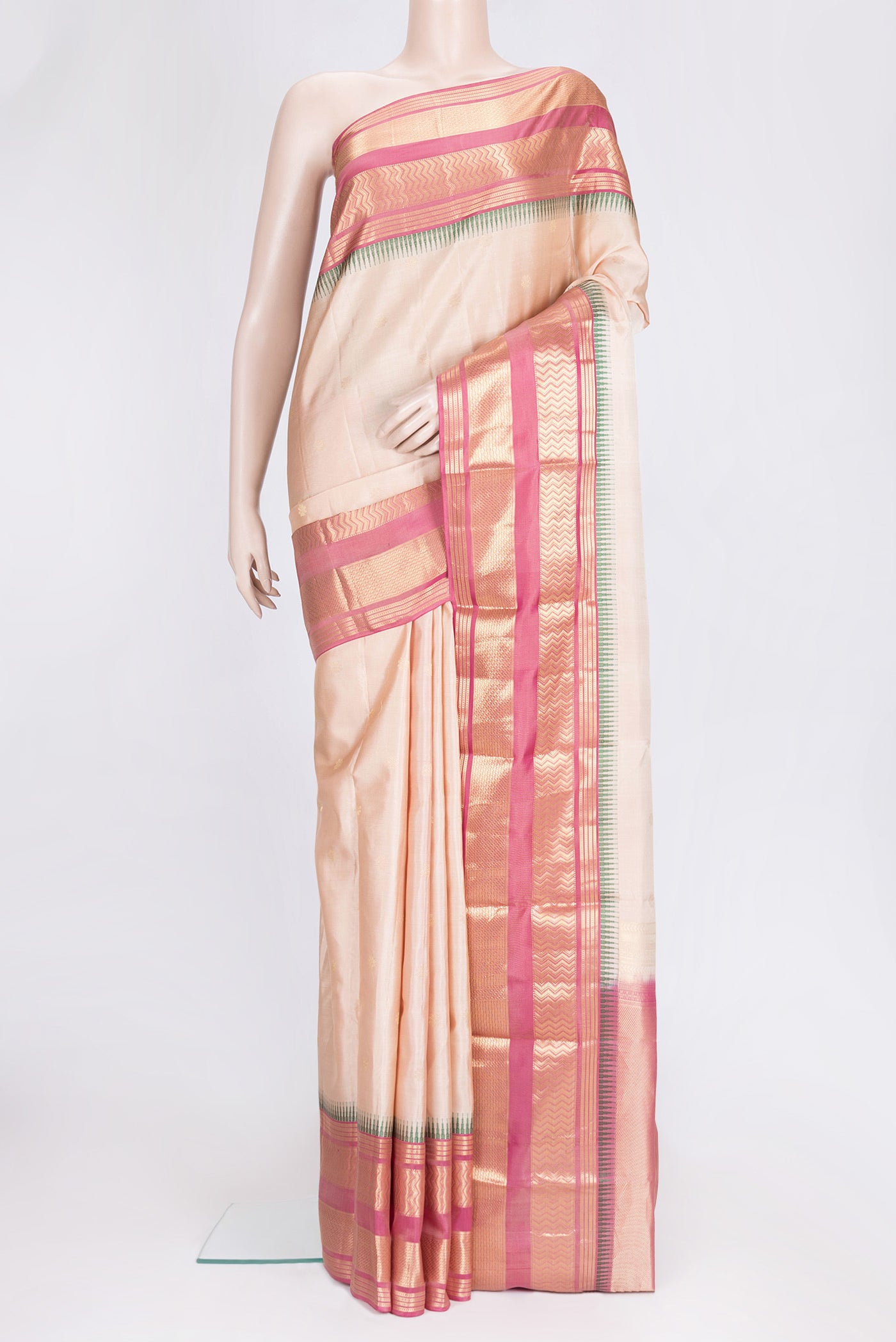 Beige Dual Tone Kanjivaram Silk Saree with Zari Butta on the body and Zari Border.  displayed on a mannequin