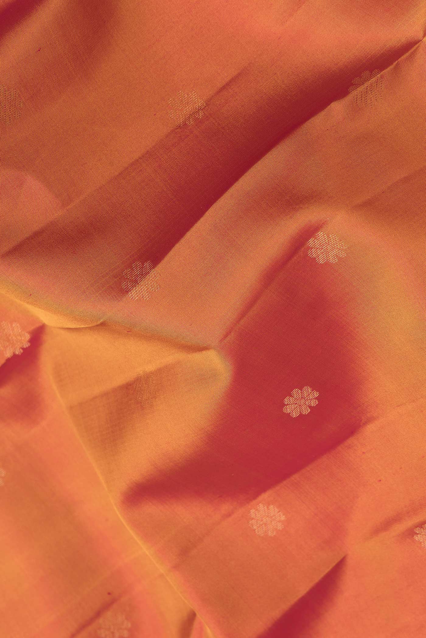 Close up of Mustard Dual Tone Kanjivaram Silk Saree with Zari Butta on the body and Zari Border.  displaying folds
