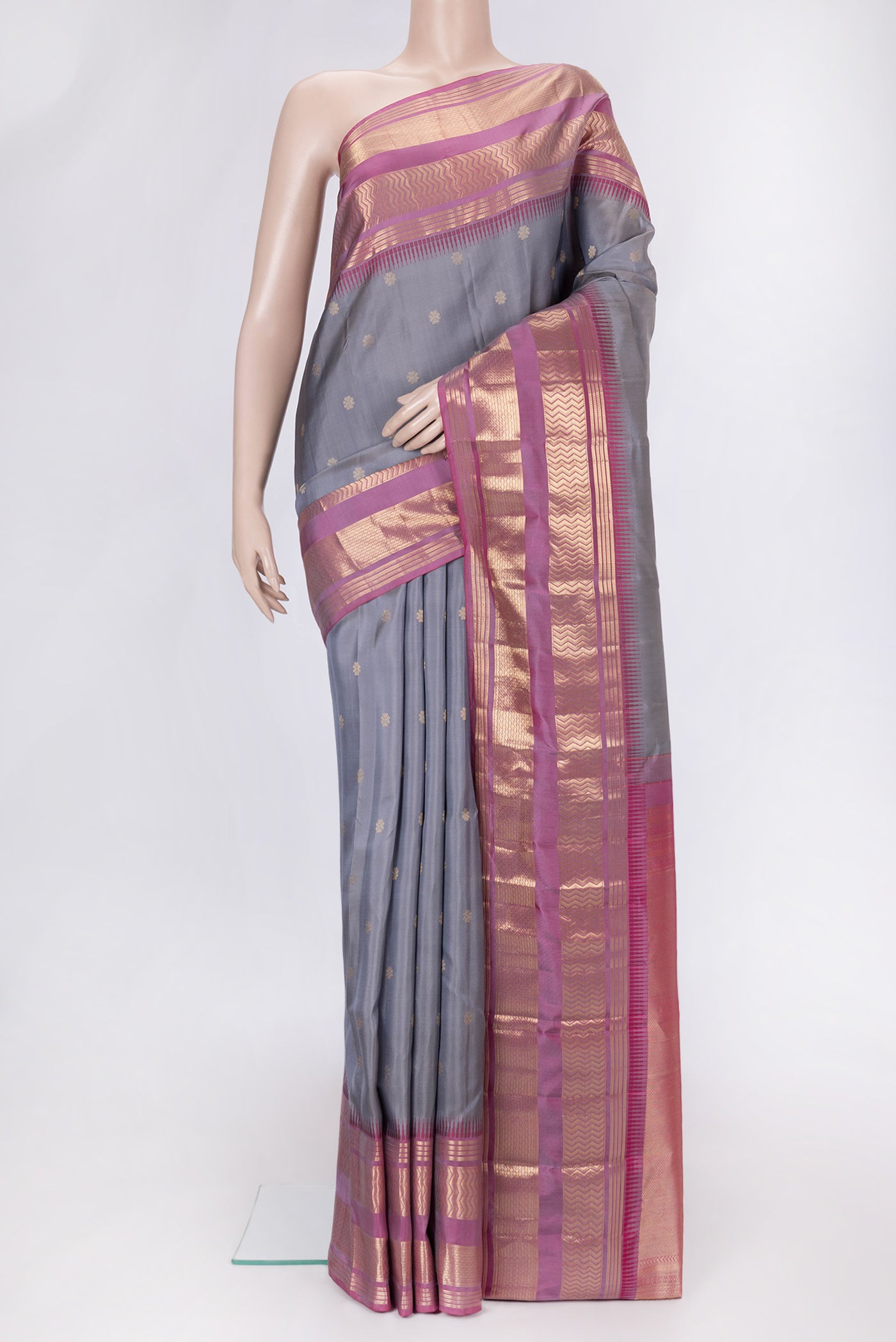 Grey Dual Tone Kanjivaram Silk Saree with Zari Butta on the body and Zari Border.  displayed on a mannequin