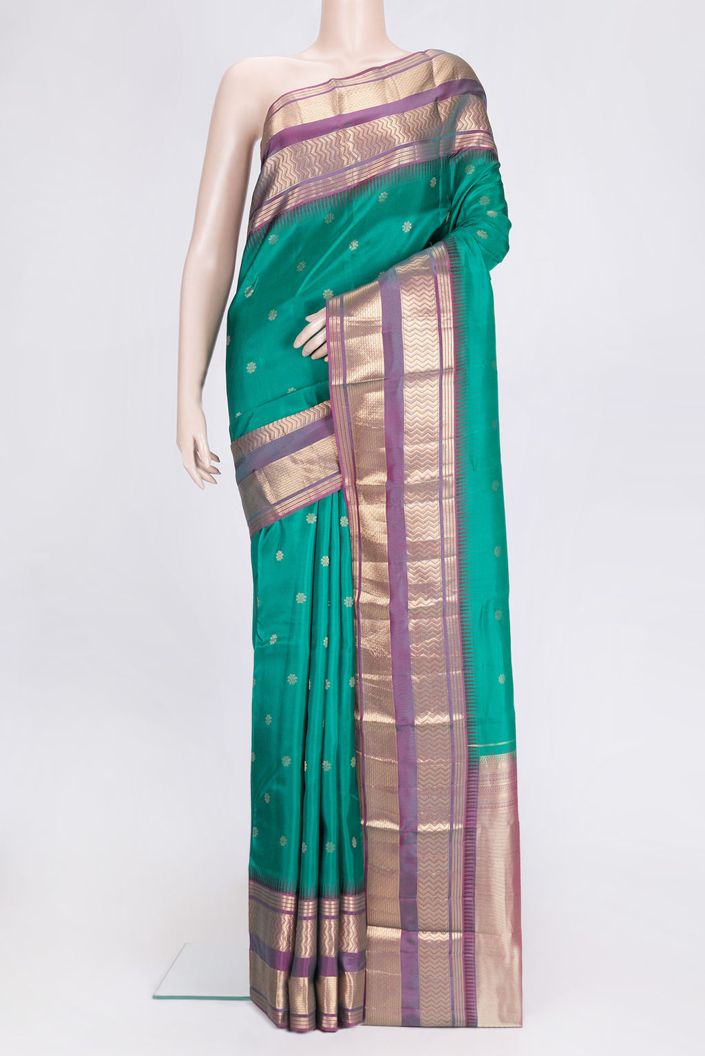 Green Dual Tone Kanjivaram Silk Saree with Zari Butta on the body and Zari Border.  displayed on a mannequin