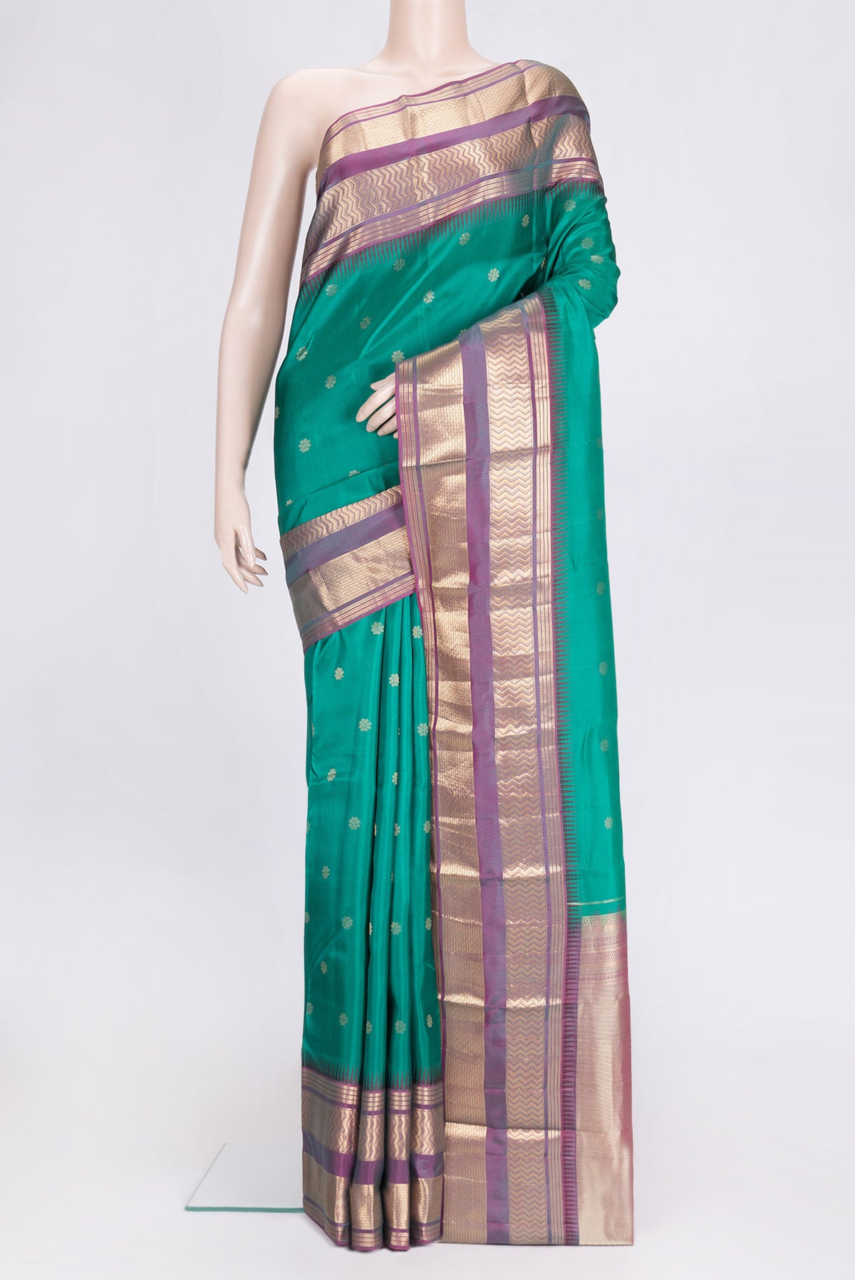Green Dual Tone Kanjivaram Silk Saree with Zari Butta on the body and Zari Border.  displayed on a mannequin