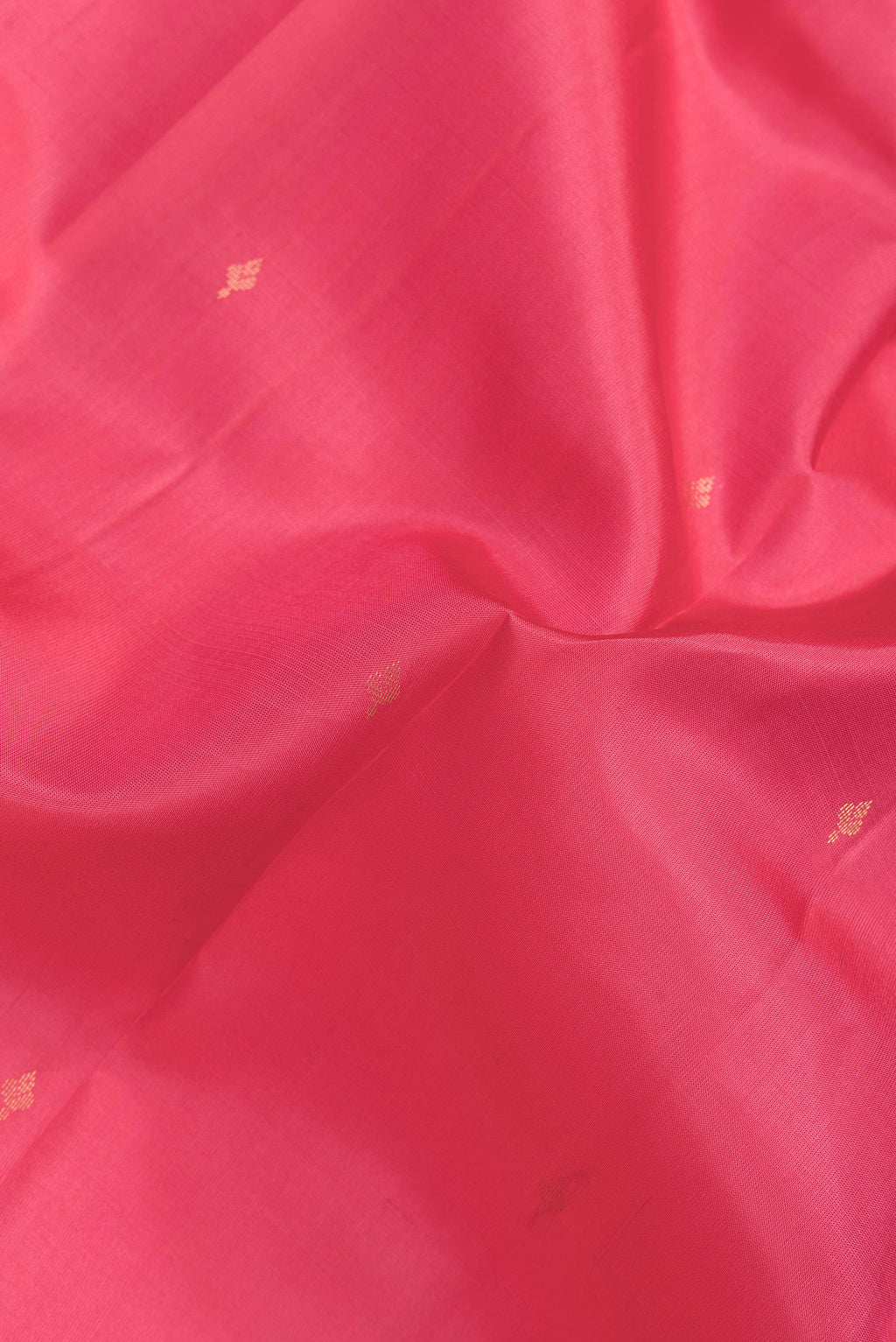 Close up of Pink Dual Tone Kanjivaram Silk Saree with Zari Butta on the body and Zari Border.  displaying folds