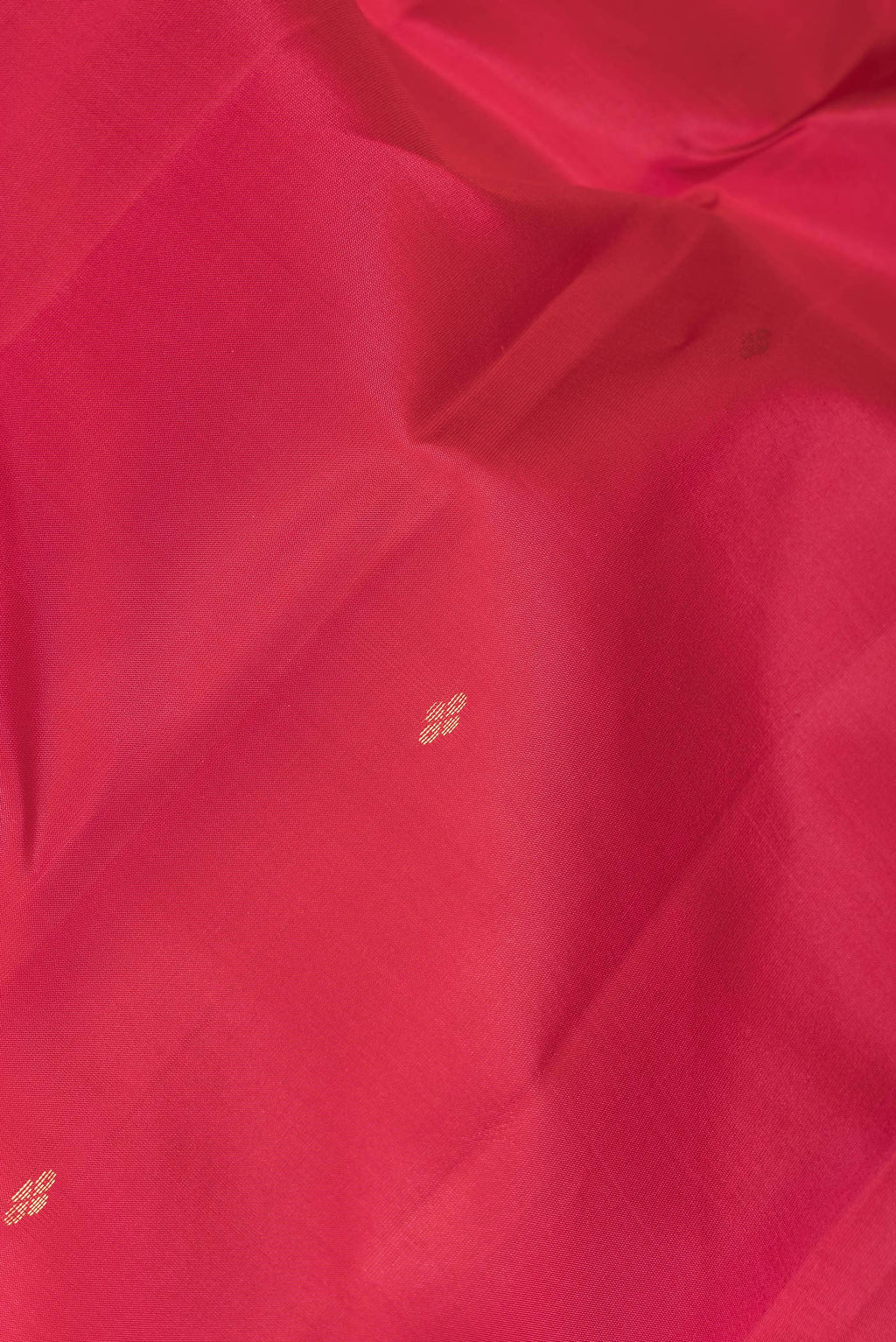 Close up of Pink Dual Tone Kanchipuram Silk Saree with Zari Butta on the body and Zari Border.  displaying folds