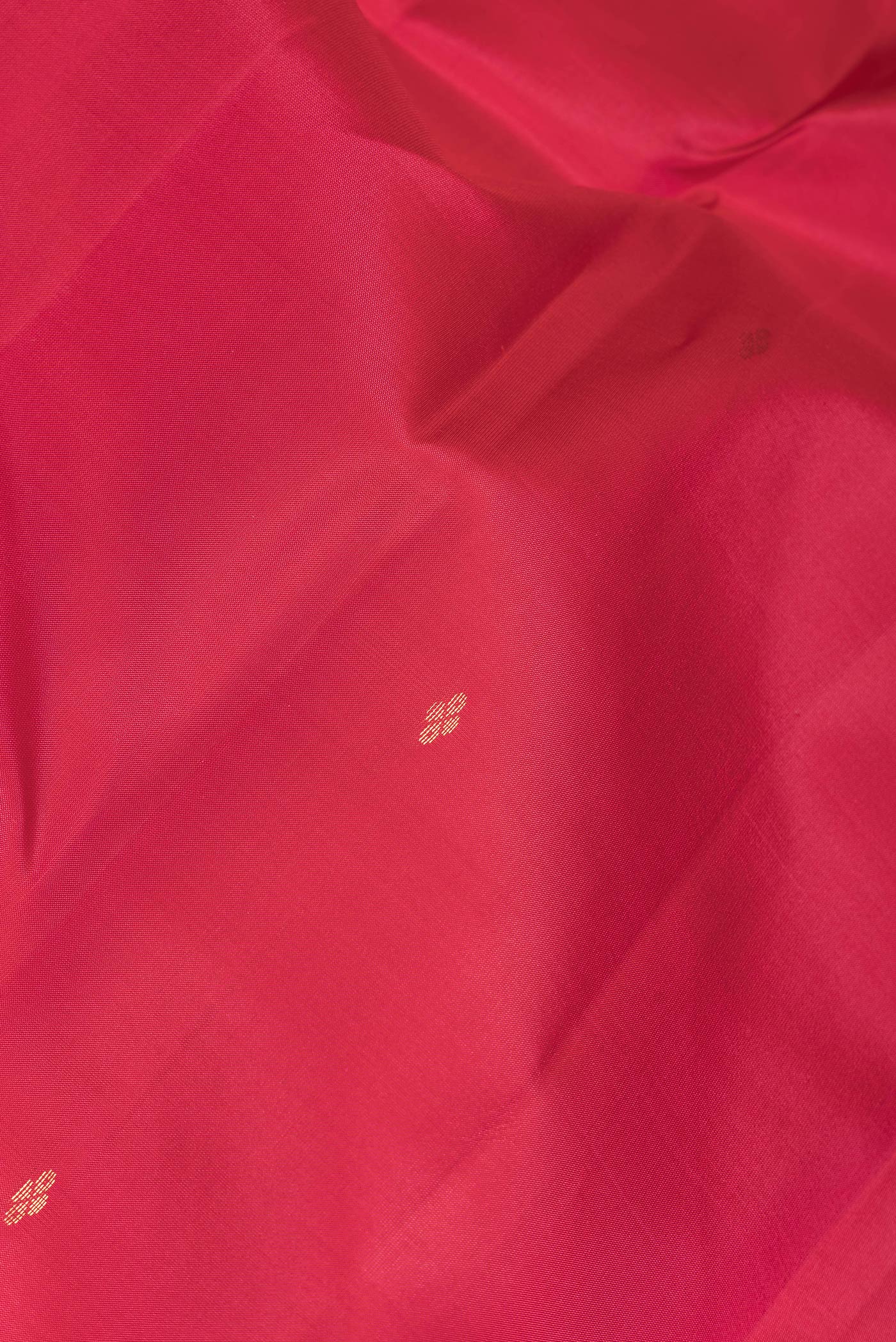 Close up of Pink Dual Tone Kanchipuram Silk Saree with Zari Butta on the body and Zari Border.  displaying folds