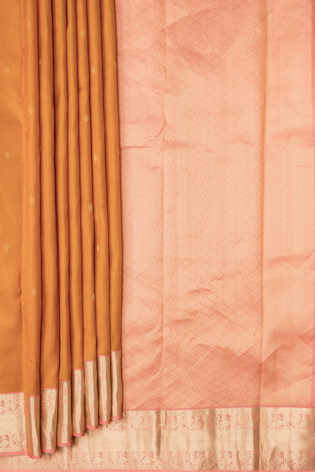 Pleats and pallu of Mustard Dual Tone Kanchipuram Silk Saree with Zari Butta on the body and Zari Border. 