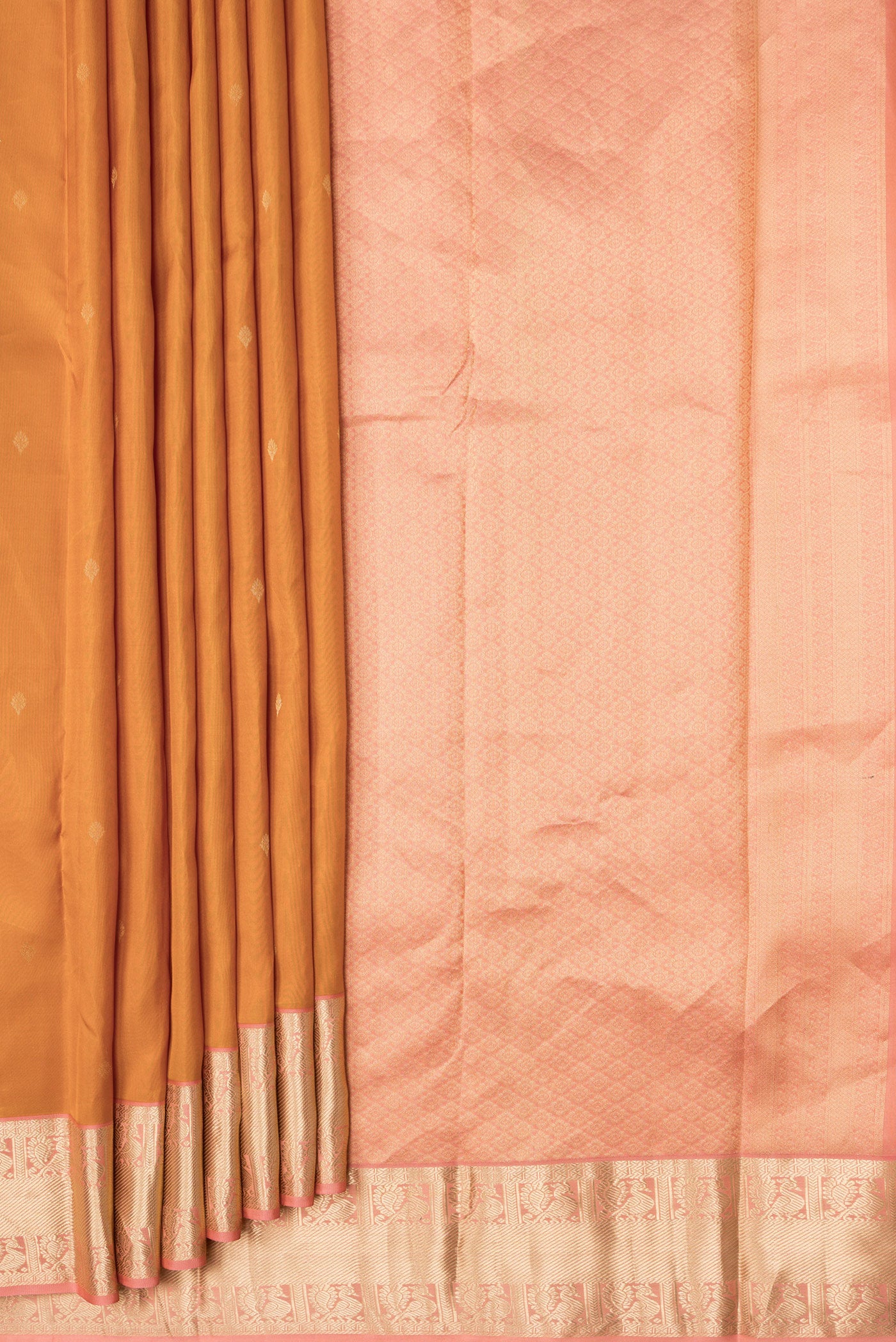 Pleats and pallu of Mustard Dual Tone Kanchipuram Silk Saree with Zari Butta on the body and Zari Border. 