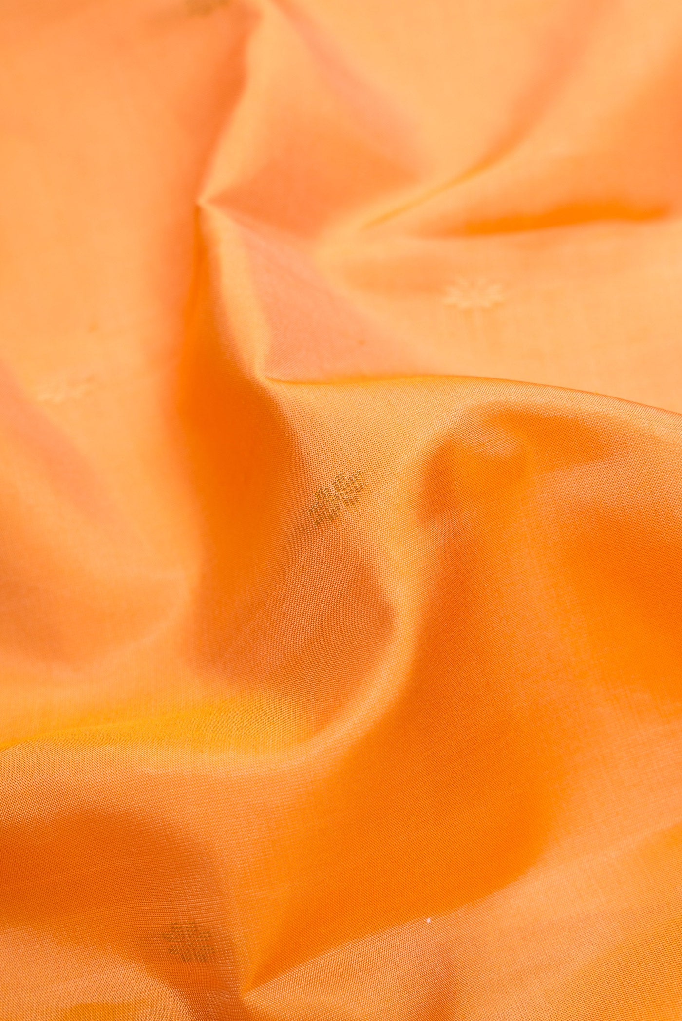Close up of Sandal Dual Tone Kanchipuram Silk Saree with Zari Butta on the body and Zari Border.  displaying folds