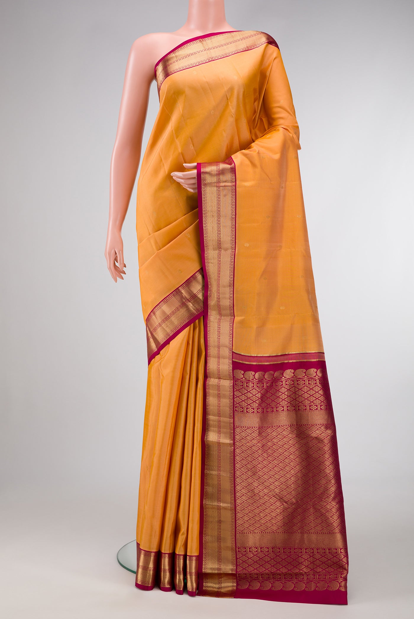 Sandal Dual Tone Kanchipuram Silk Saree with Zari Butta on the body and Zari Border.  displayed on a mannequin