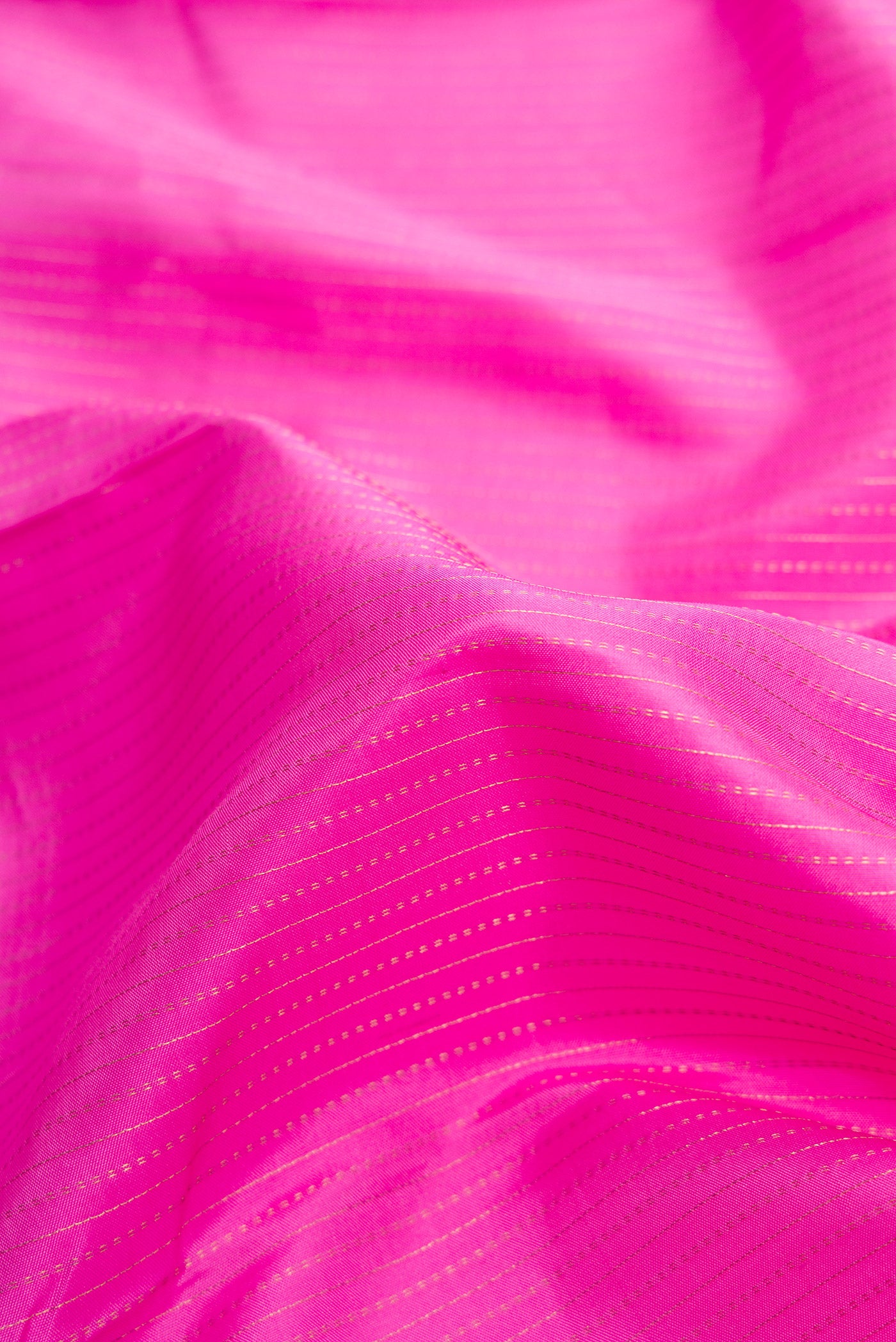 Close up of Pink Dual Tone Kanjivaram Silk Saree with Stripes on the body and Zari Border.  displaying folds