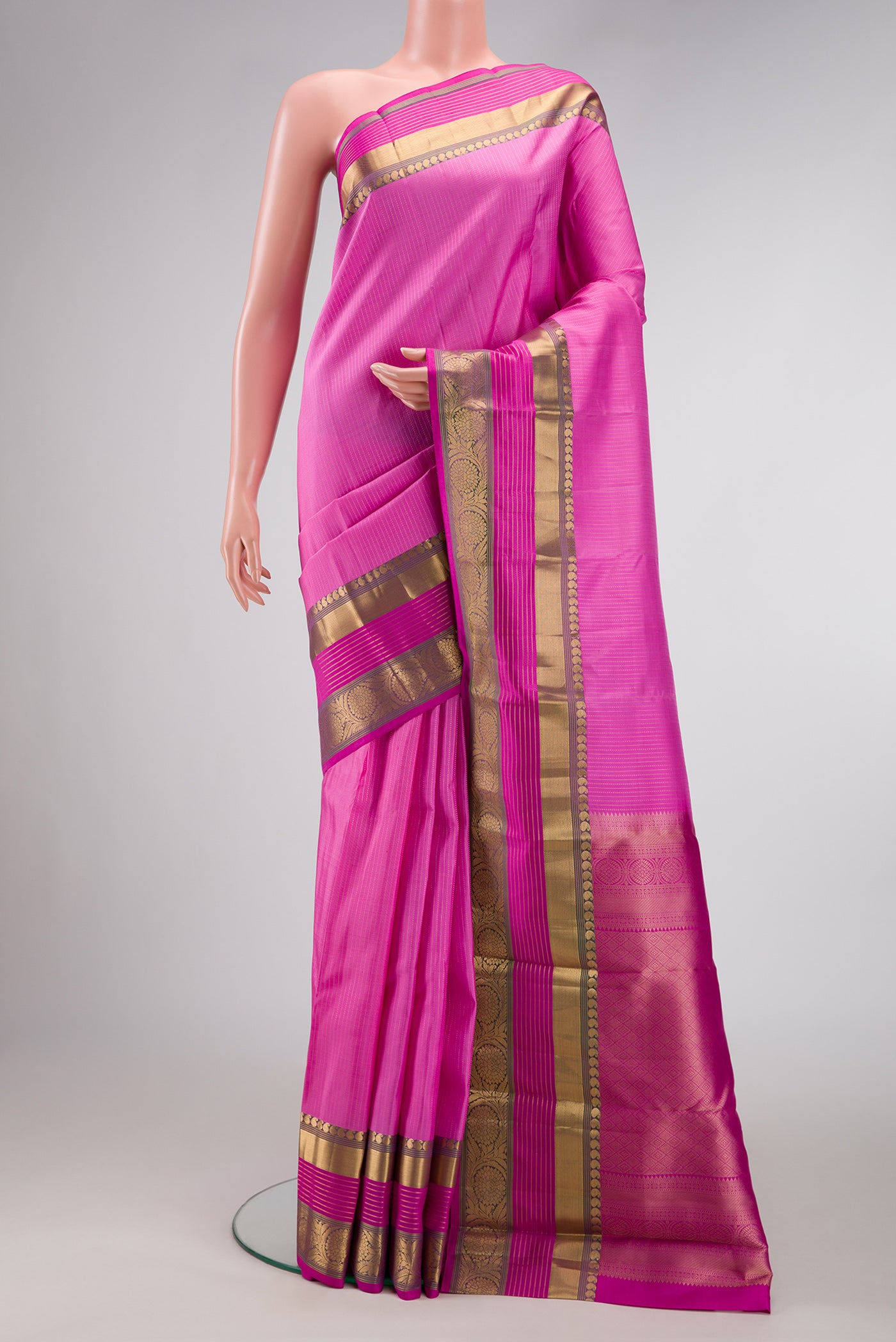 Pink Dual Tone Kanjivaram Silk Saree with Stripes on the body and Zari Border.  displayed on a mannequin
