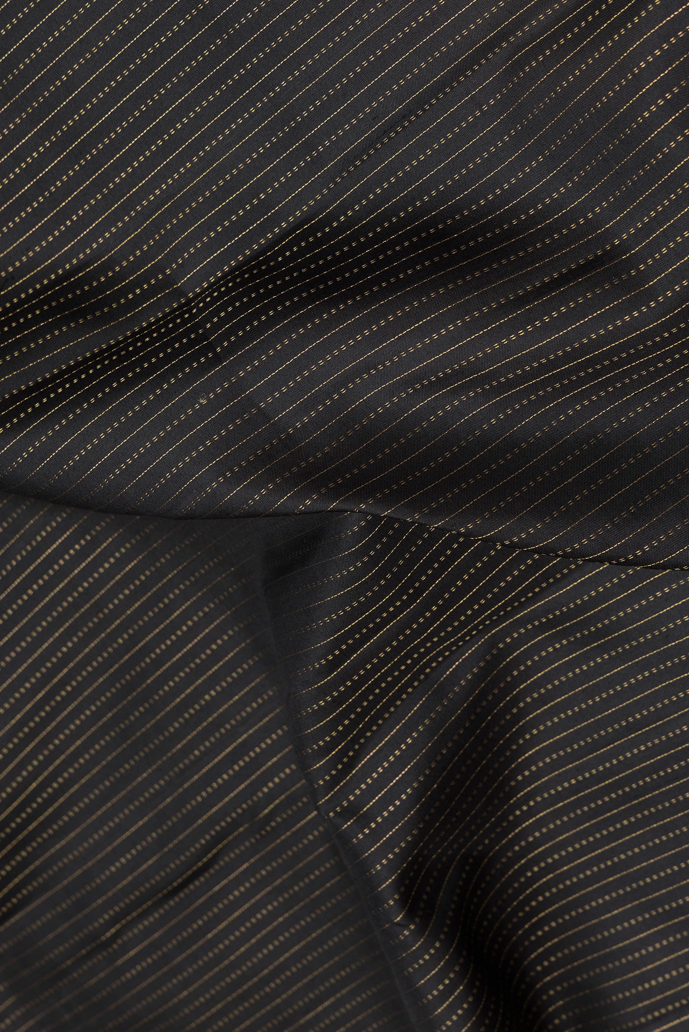 Close up of Black Dual Tone Kanjivaram Silk Saree with Stripes on the body and Zari Border.  displaying folds