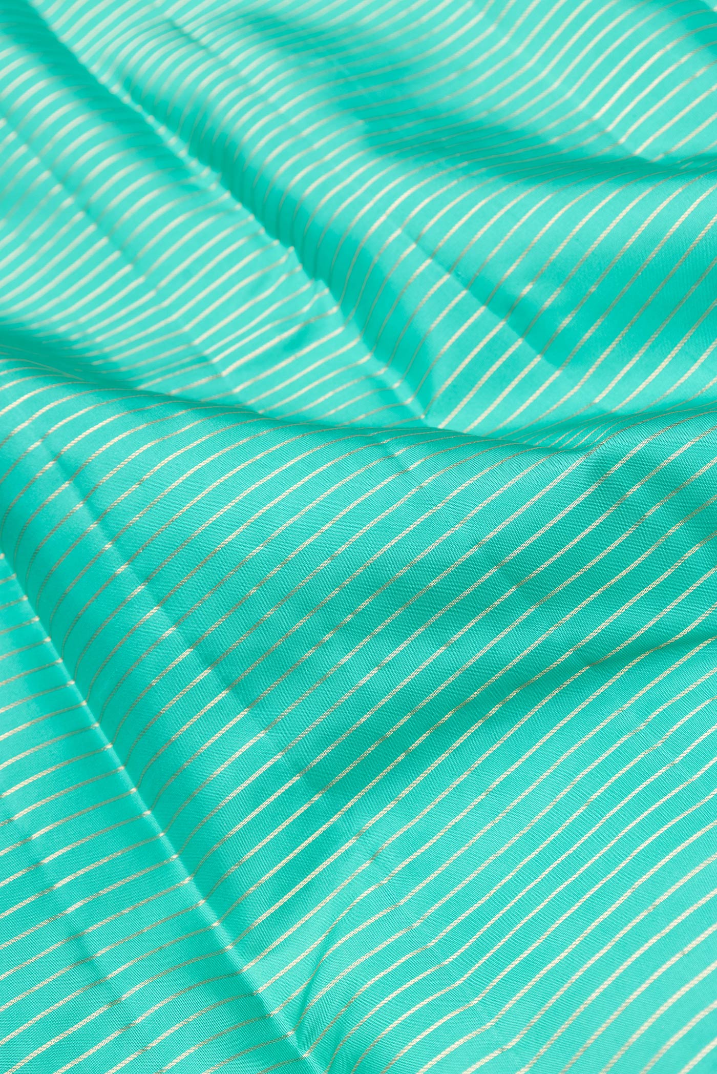 Close up of Sea Green Dual Tone Kanjivaram Silk Saree with Stripes on the body and Zari Border.  displaying folds