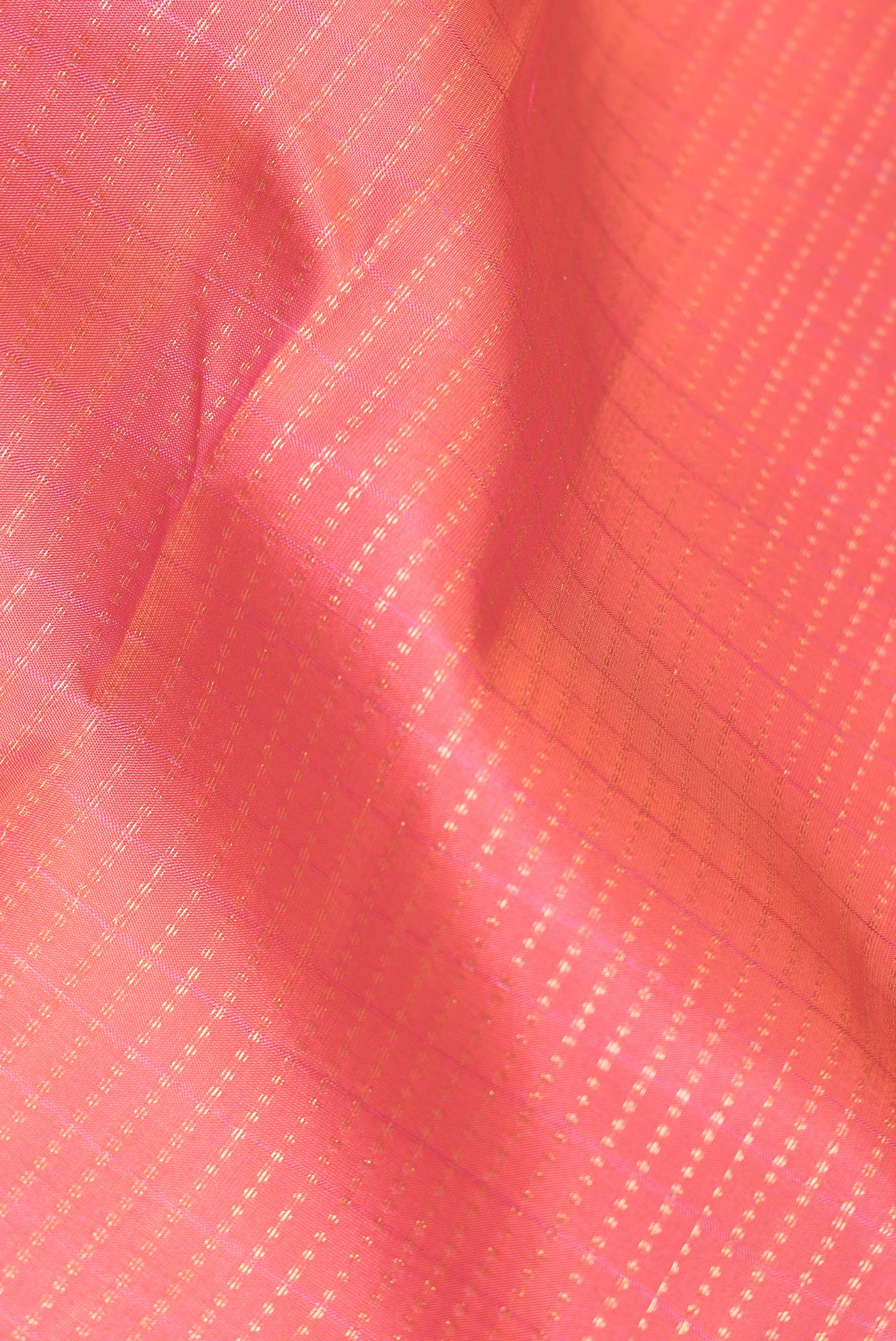 Close up of Peach Dual Tone Kanchipuram Silk Saree with Stripes on the body and Zari Border.  displaying folds