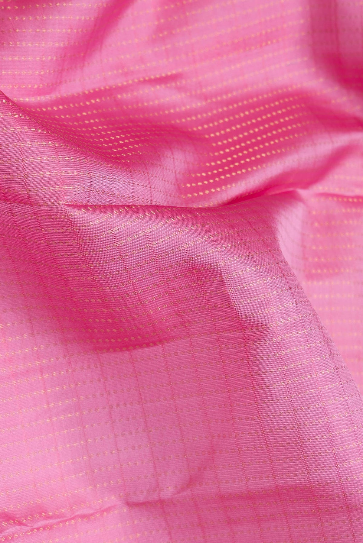 Close up of Pink Dual Tone Kanchipuram Silk Saree with Stripes on the body and Zari Border.  displaying folds