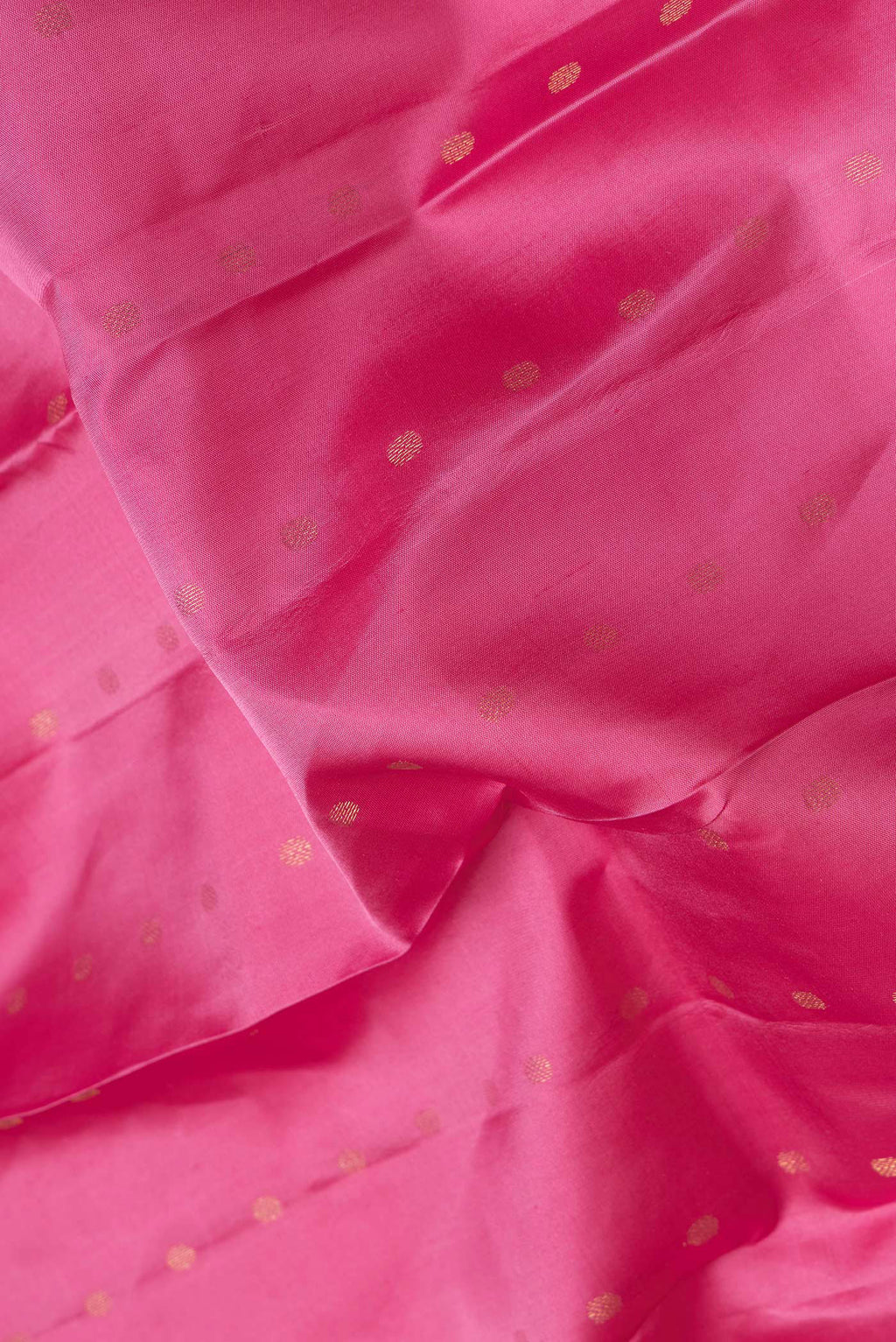 Close up of Pink Dual Tone Kanchipuram Silk Saree with Zari Butta on the body and Zari Border.  displaying folds