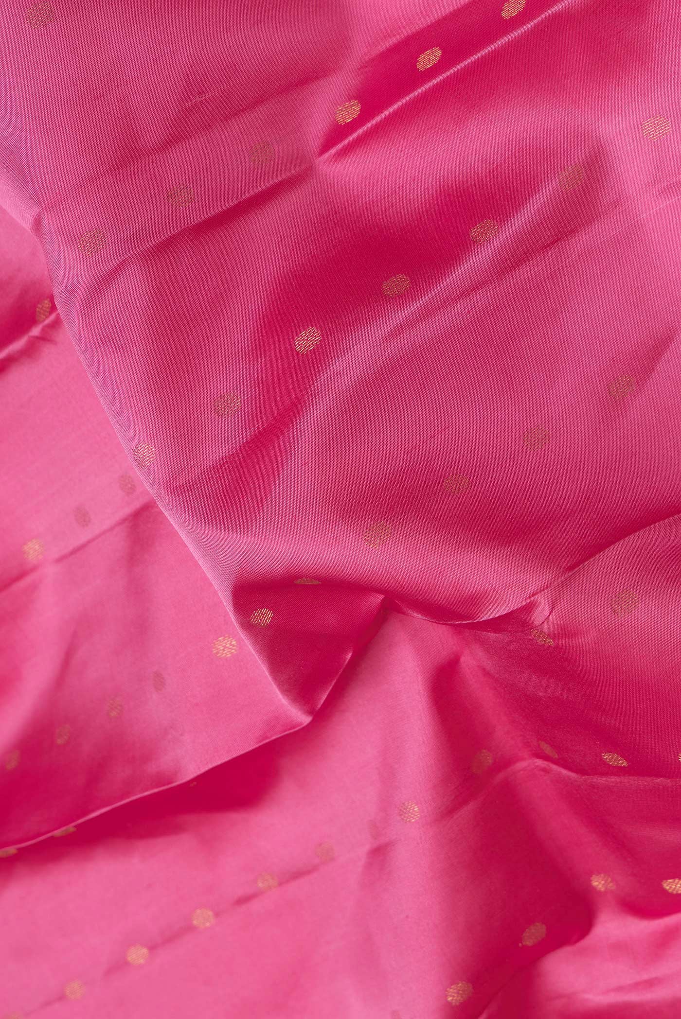 Close up of Pink Dual Tone Kanchipuram Silk Saree with Zari Butta on the body and Zari Border.  displaying folds