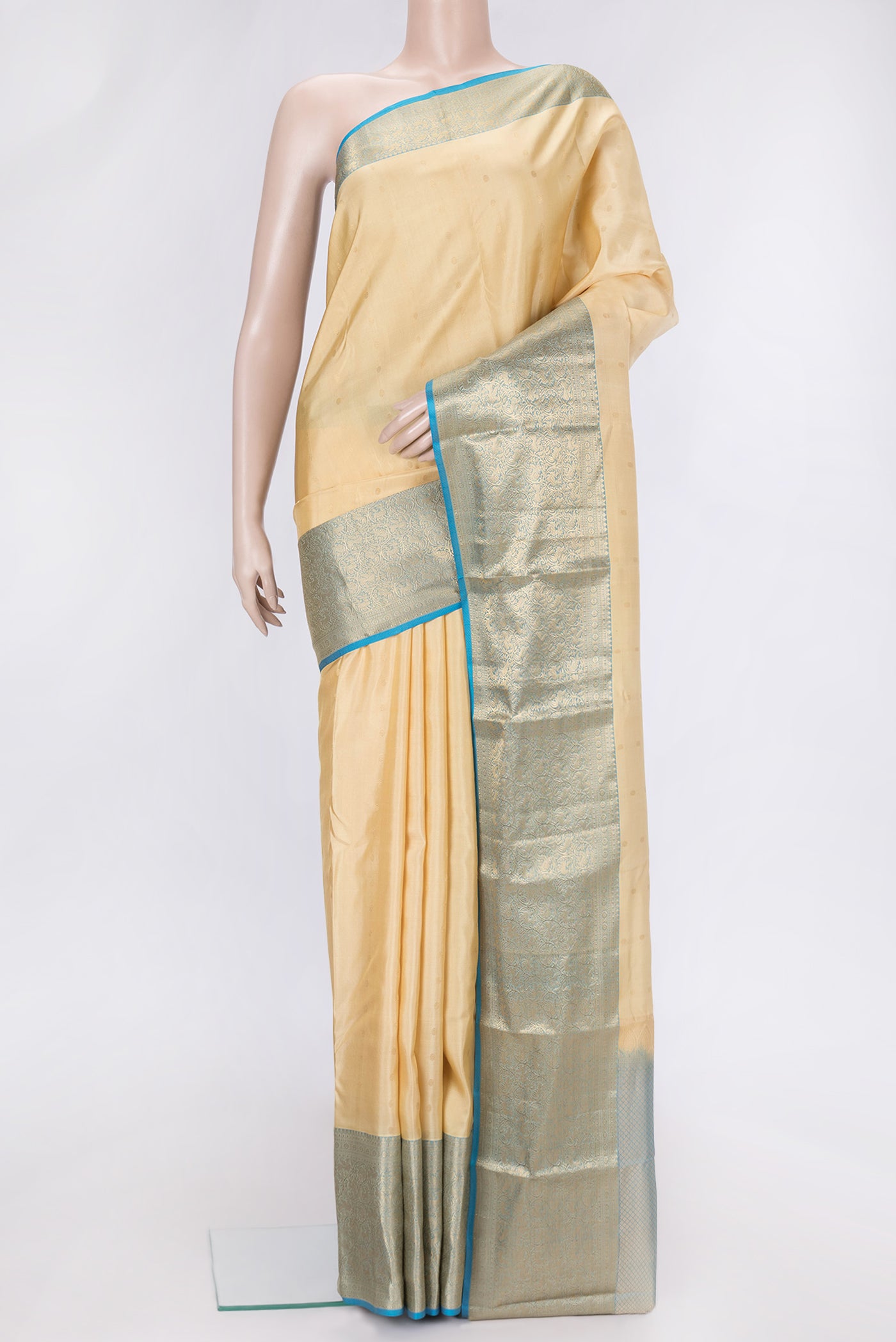 Sandal Dual Tone Kanchipuram Silk Saree with Zari Butta on the body and Zari Border.  displayed on a mannequin