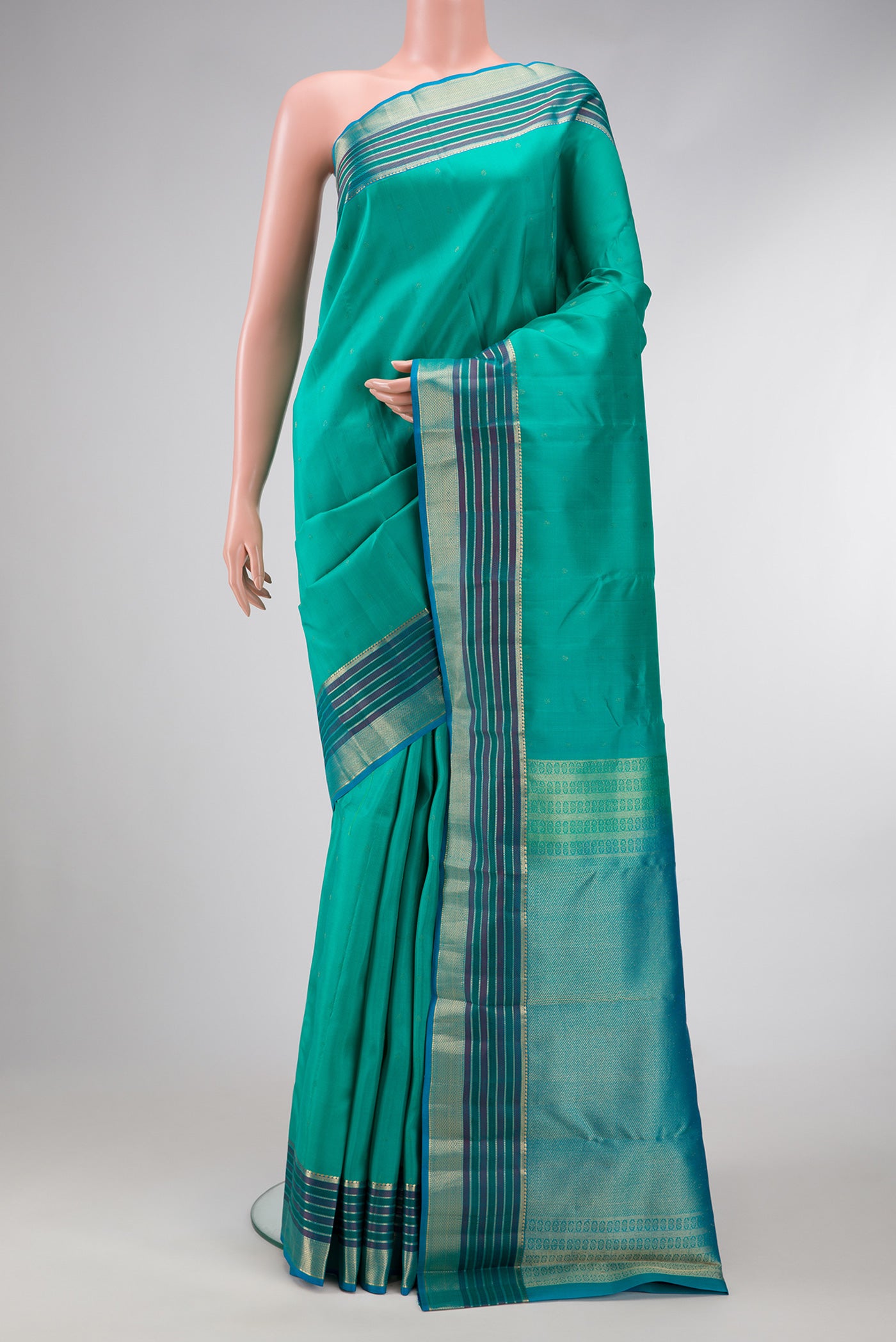 Sea Green Dual Tone Kanchipuram Silk Saree with Zari Butta on the body and Zari And Thread Border.  displayed on a mannequin