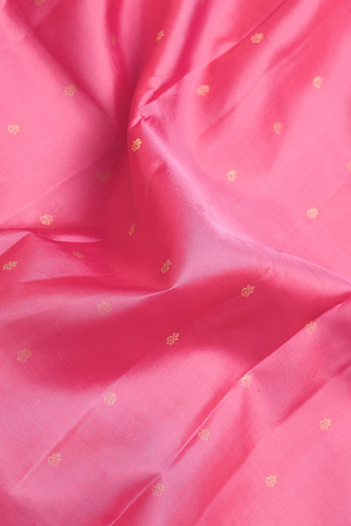 Close up of Pink Dual Tone Kanchipuram Silk Saree with Zari Butta on the body and Zari Border.  displaying folds