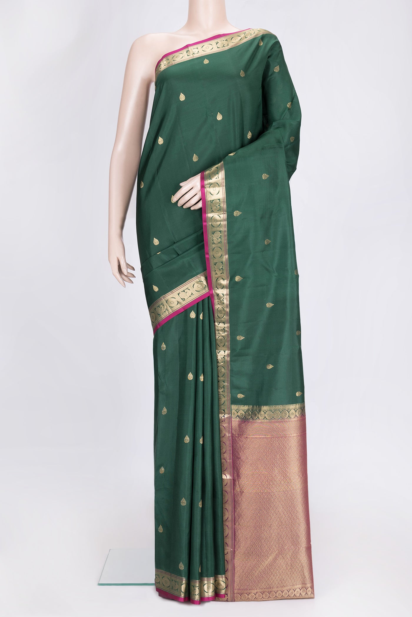 Green Dual Tone Kanchipuram Silk Saree with Zari Butta on the body and Zari Border.  displayed on a mannequin