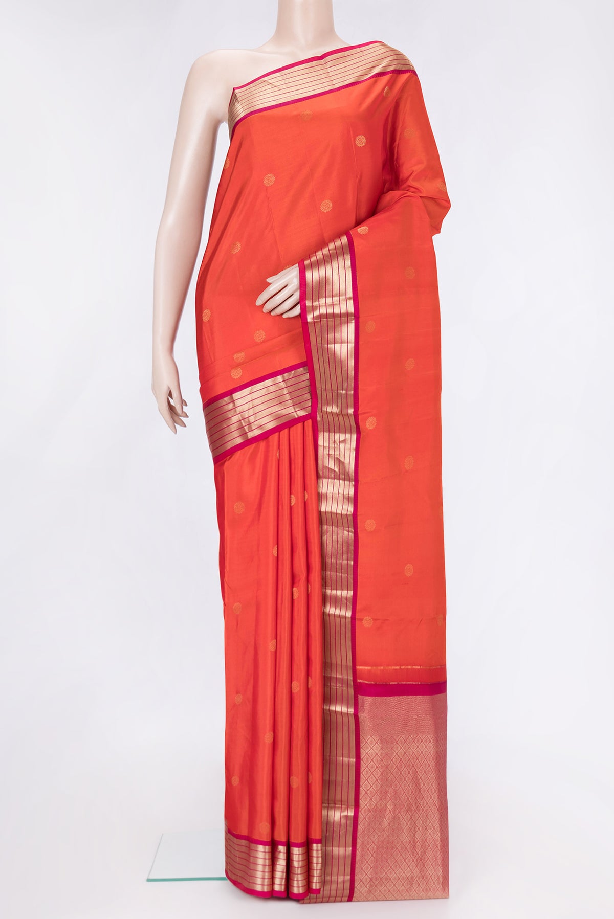 Orange Dual Tone Kanchipuram Silk Saree with Zari Butta on the body and Zari Border.  displayed on a mannequin