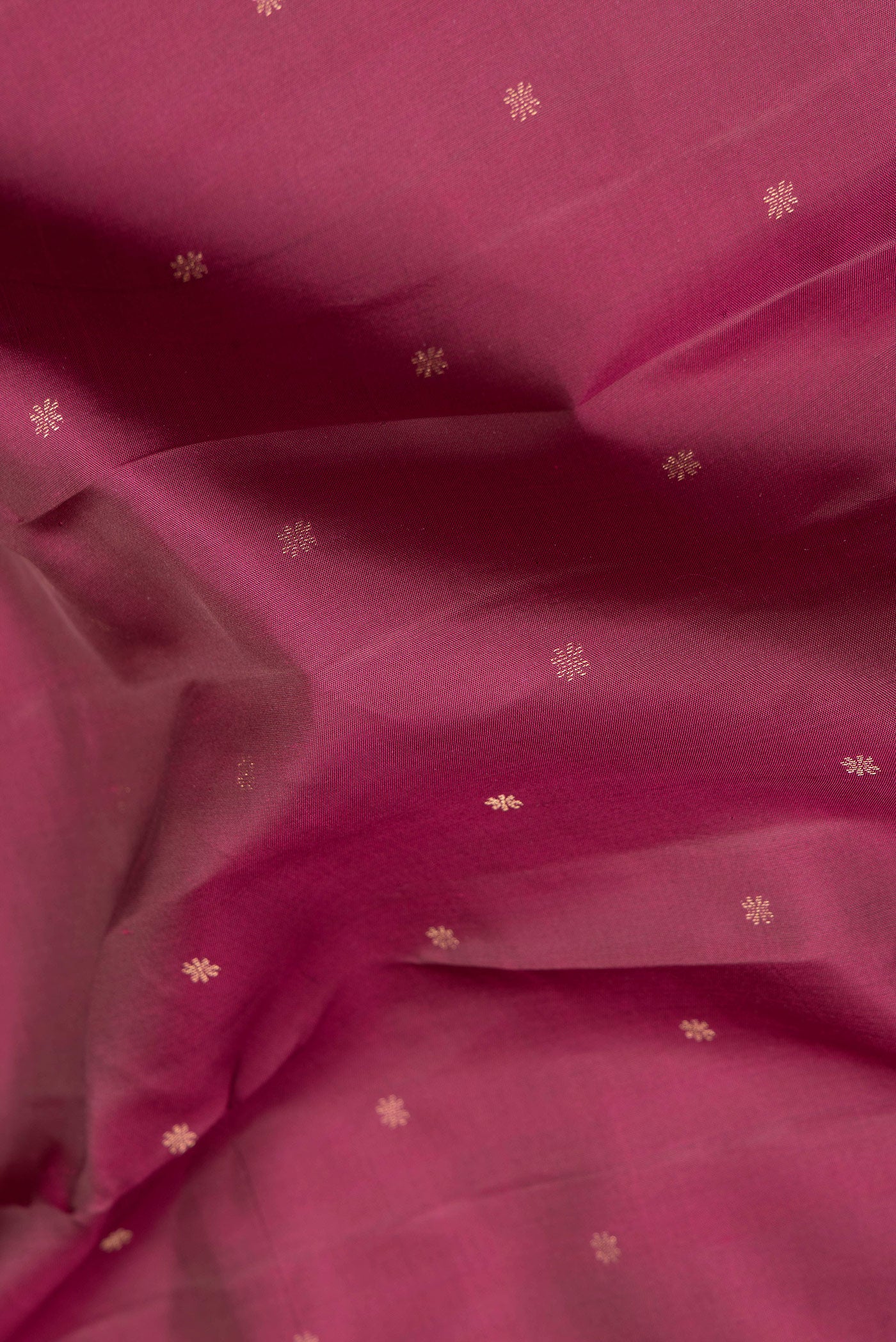 Close up of Maroon Dual Tone Kanchipuram Silk Saree with Zari Butta on the body and Zari Border.  displaying folds