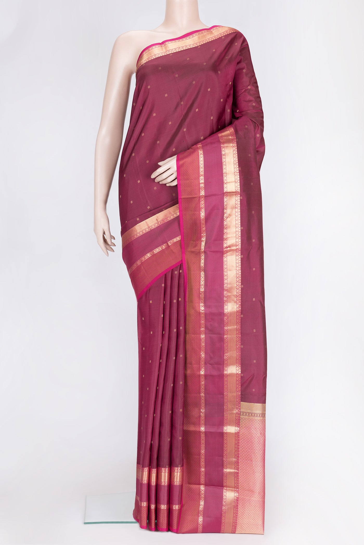 Maroon Dual Tone Kanchipuram Silk Saree with Zari Butta on the body and Zari Border.  displayed on a mannequin
