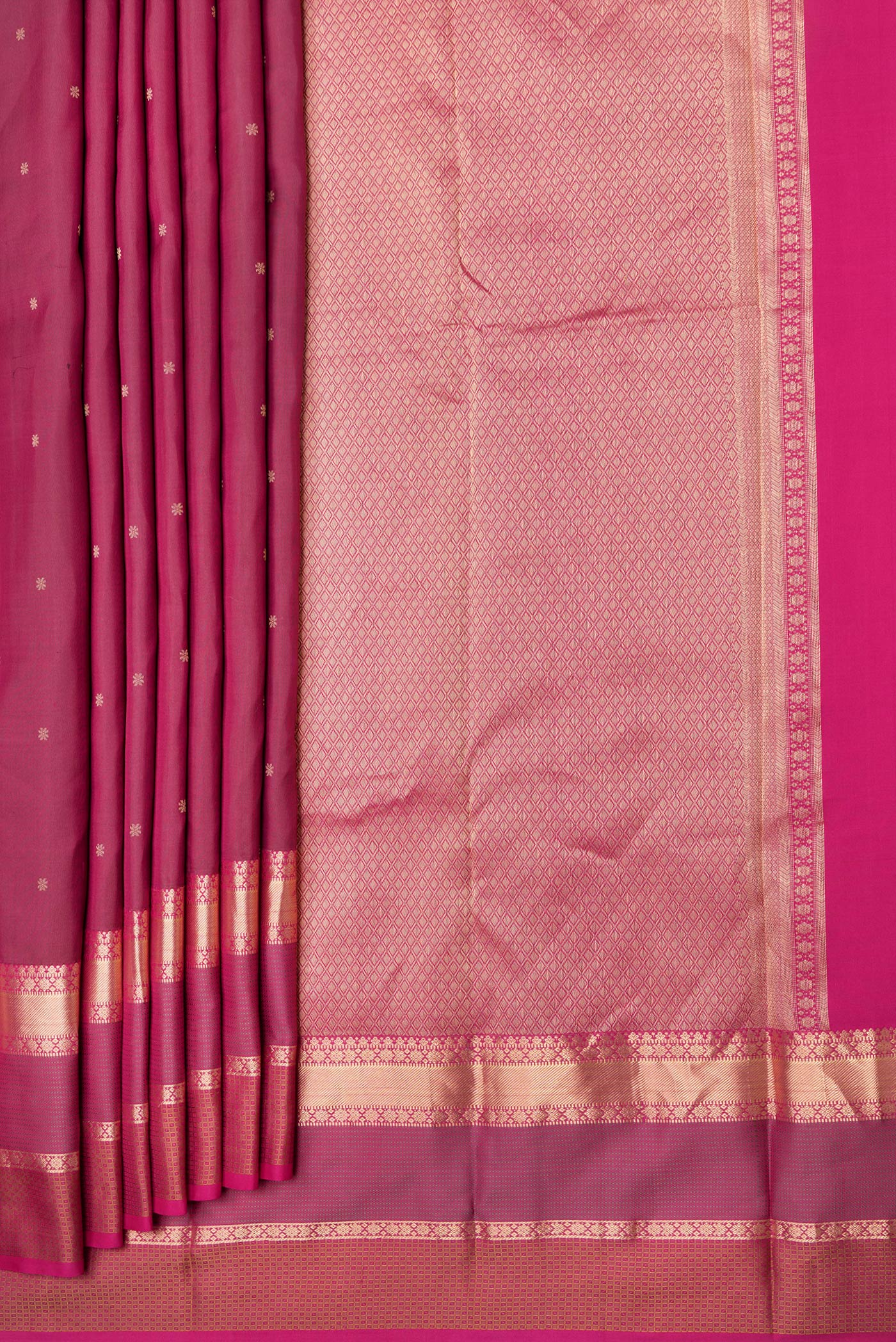 Pleats and pallu of Maroon Dual Tone Kanchipuram Silk Saree with Zari Butta on the body and Zari Border. 