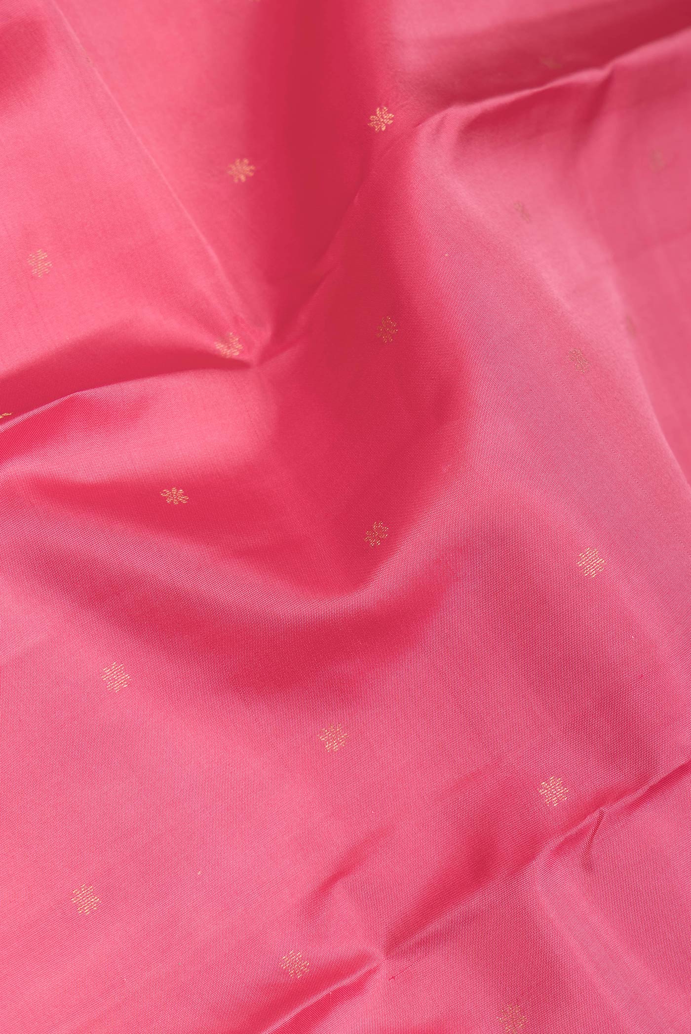 Close up of Pink Dual Tone Kanchipuram Silk Saree with Zari Butta on the body and Zari Border.  displaying folds