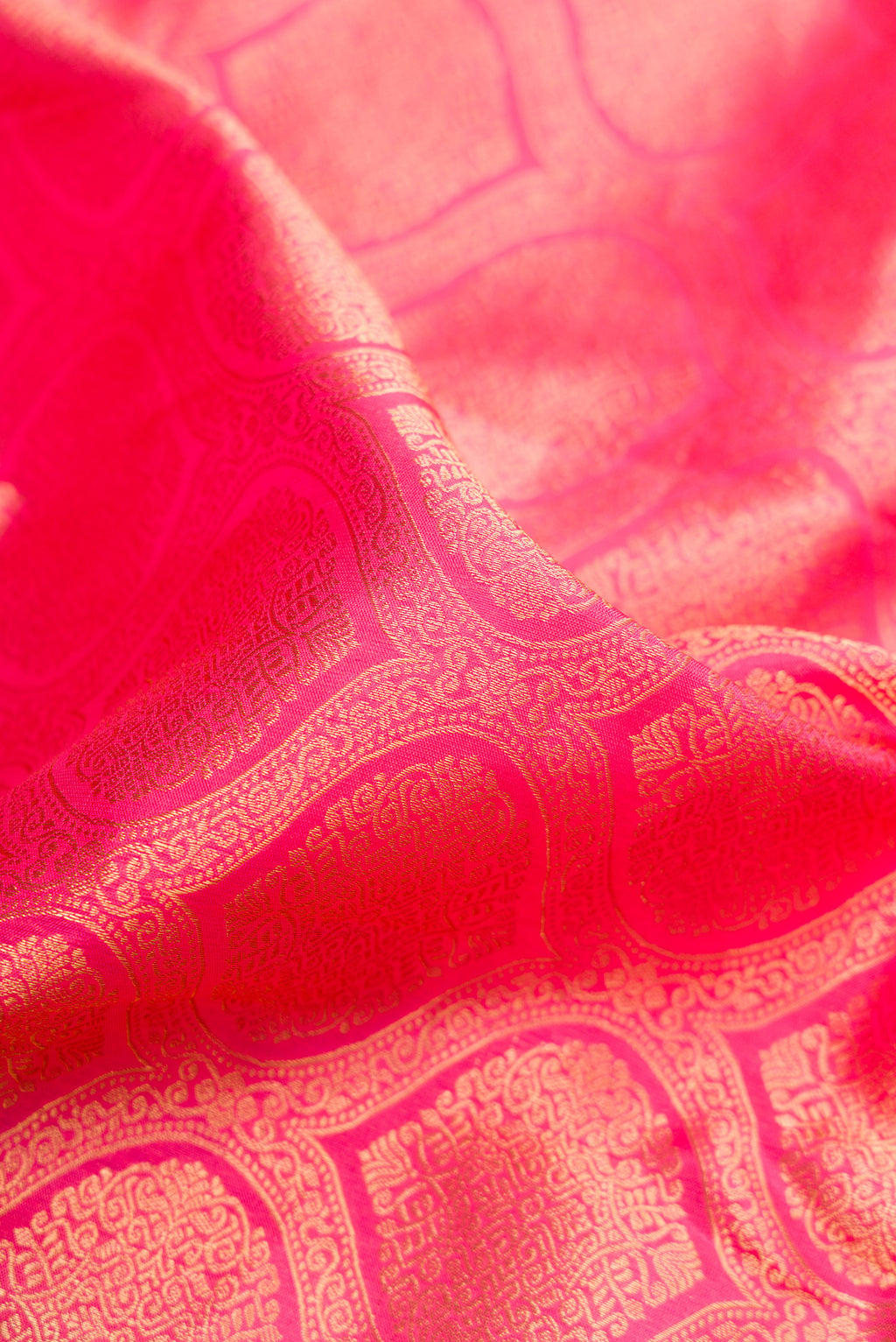 Close up of Pink Kanjivaram Silk Saree with Zari Brocade on the body and Zari Border.  displaying folds