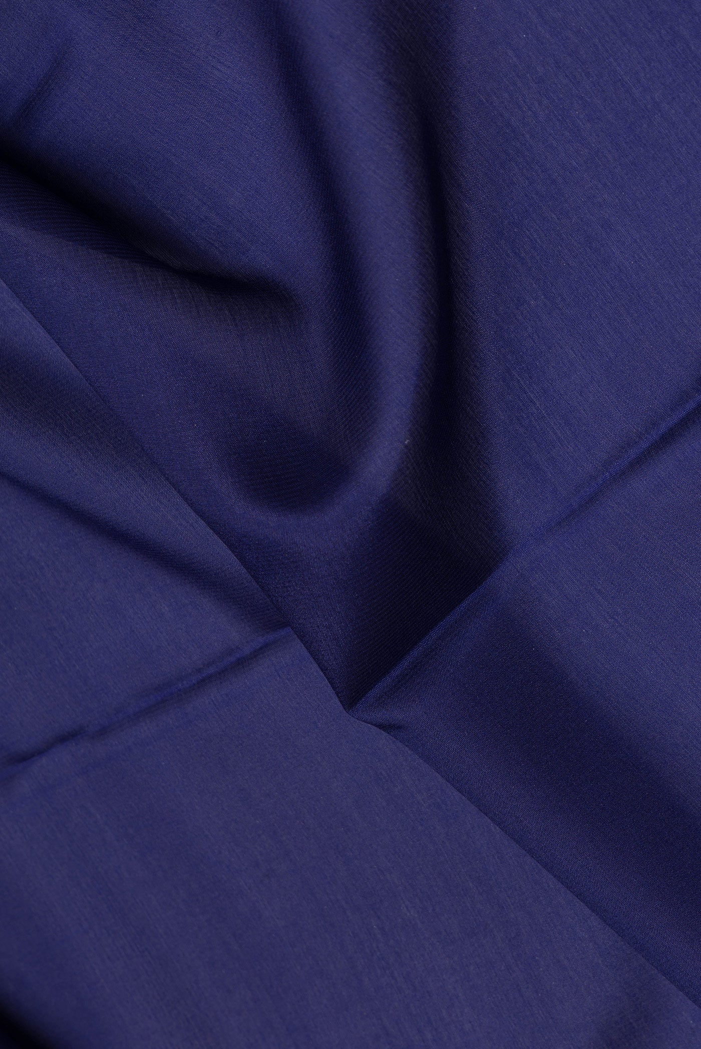 Close up of Navy Blue Mysore Silk Saree with Plain Body and Zari Border.  displaying folds