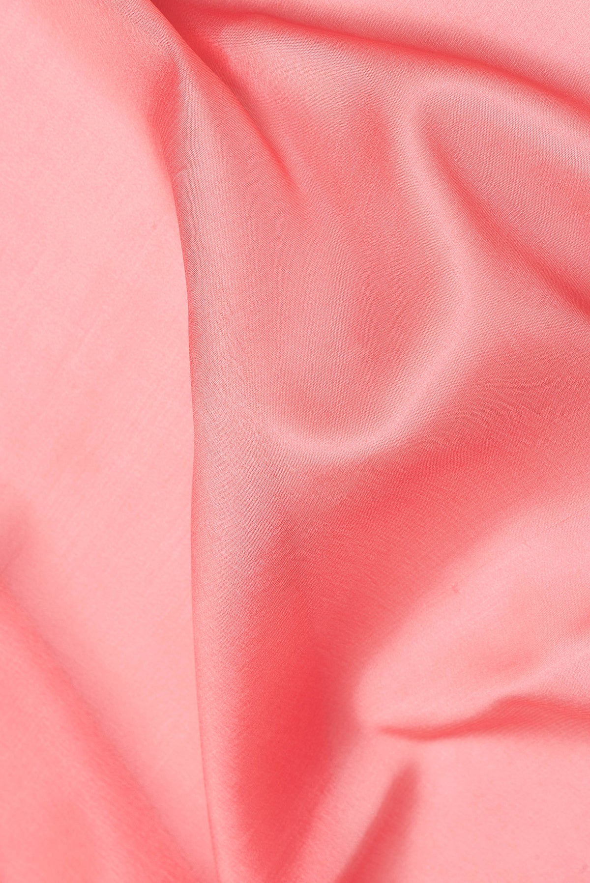Close up of Peach Mysore Crepe Saree with Plain Body and Zari Border.  displaying folds
