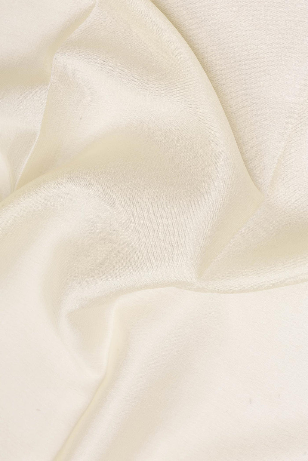 Close up of Off White Mysore Crepe Saree with Plain Body and Zari Border.  displaying folds
