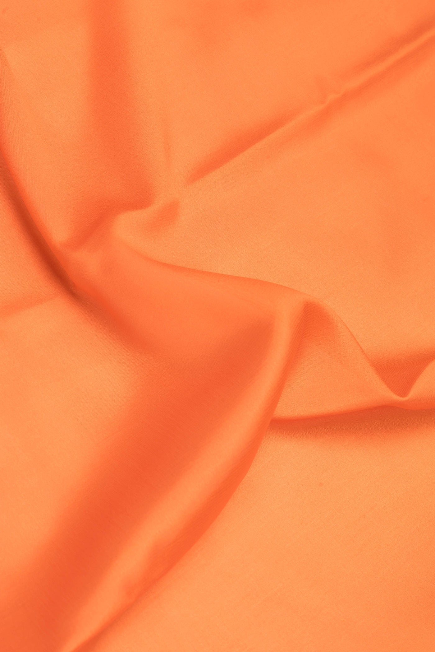 Close up of Orange Mysore Silk Saree with Plain Body and Zari Border.  displaying folds