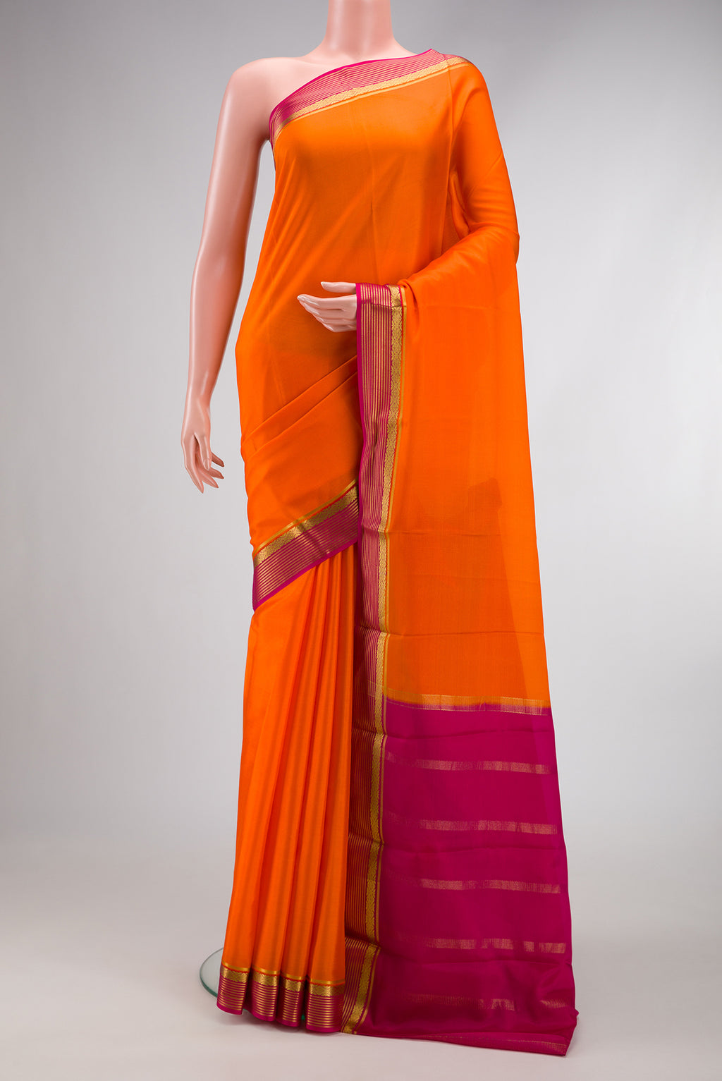 Orange Dual Tone Mysore Silk Saree with Plain Body and Zari Border.  displayed on a mannequin