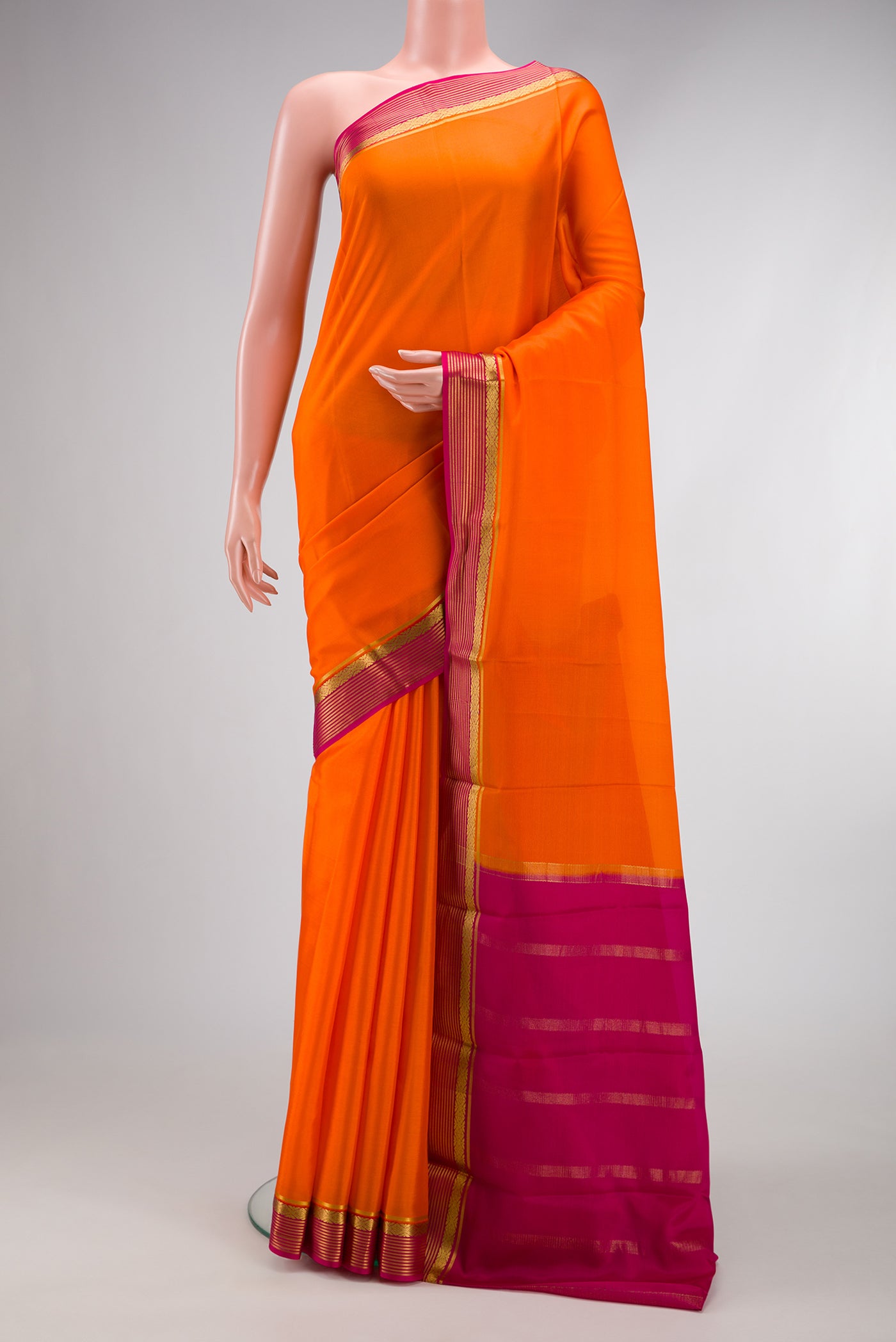 Orange Dual Tone Mysore Silk Saree with Plain Body and Zari Border.  displayed on a mannequin
