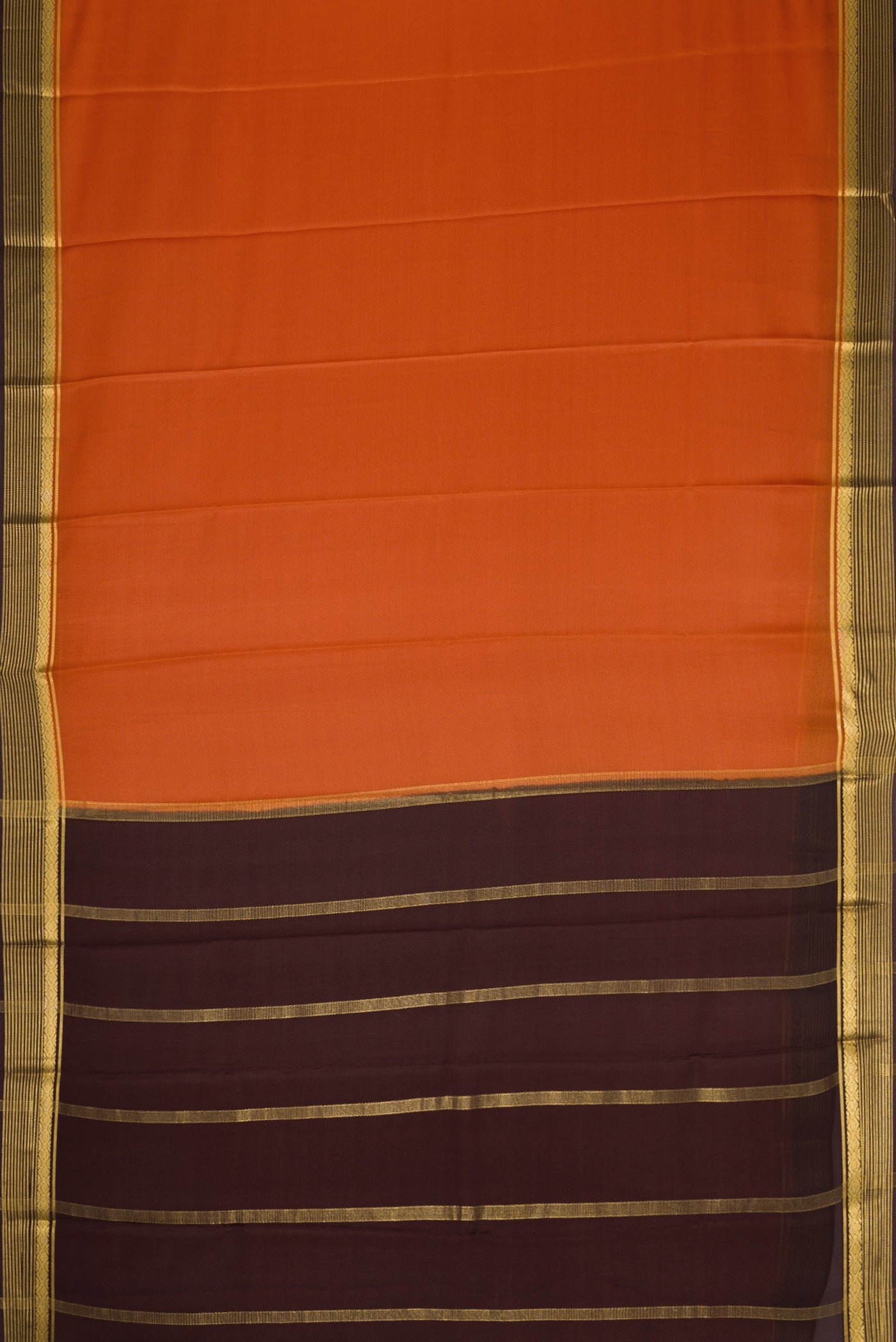 Rust Dual Tone Mysore Crepe Saree with Plain Body and Zari Border.  displayed on a mannequin