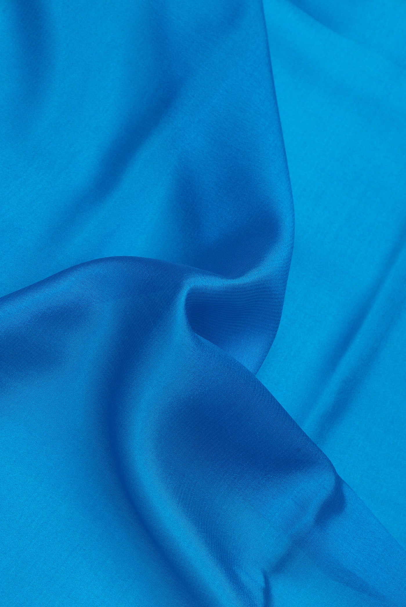 Close up of Royal Blue Dual Tone Mysore Silk Saree with Plain Body and Zari Border.  displaying folds