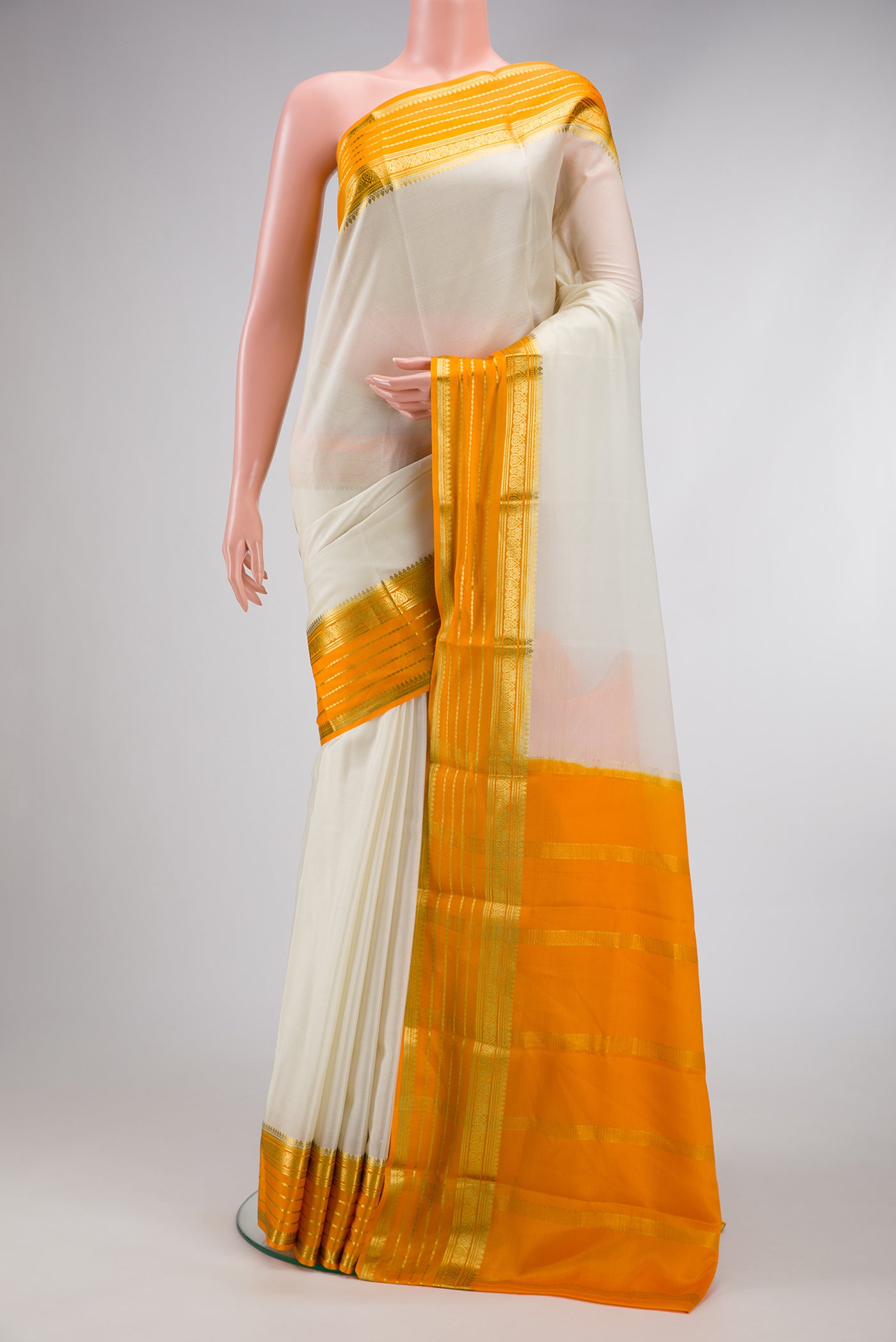 Off White Dual Tone Mysore Silk Saree with Plain Body and Zari Border.  displayed on a mannequin