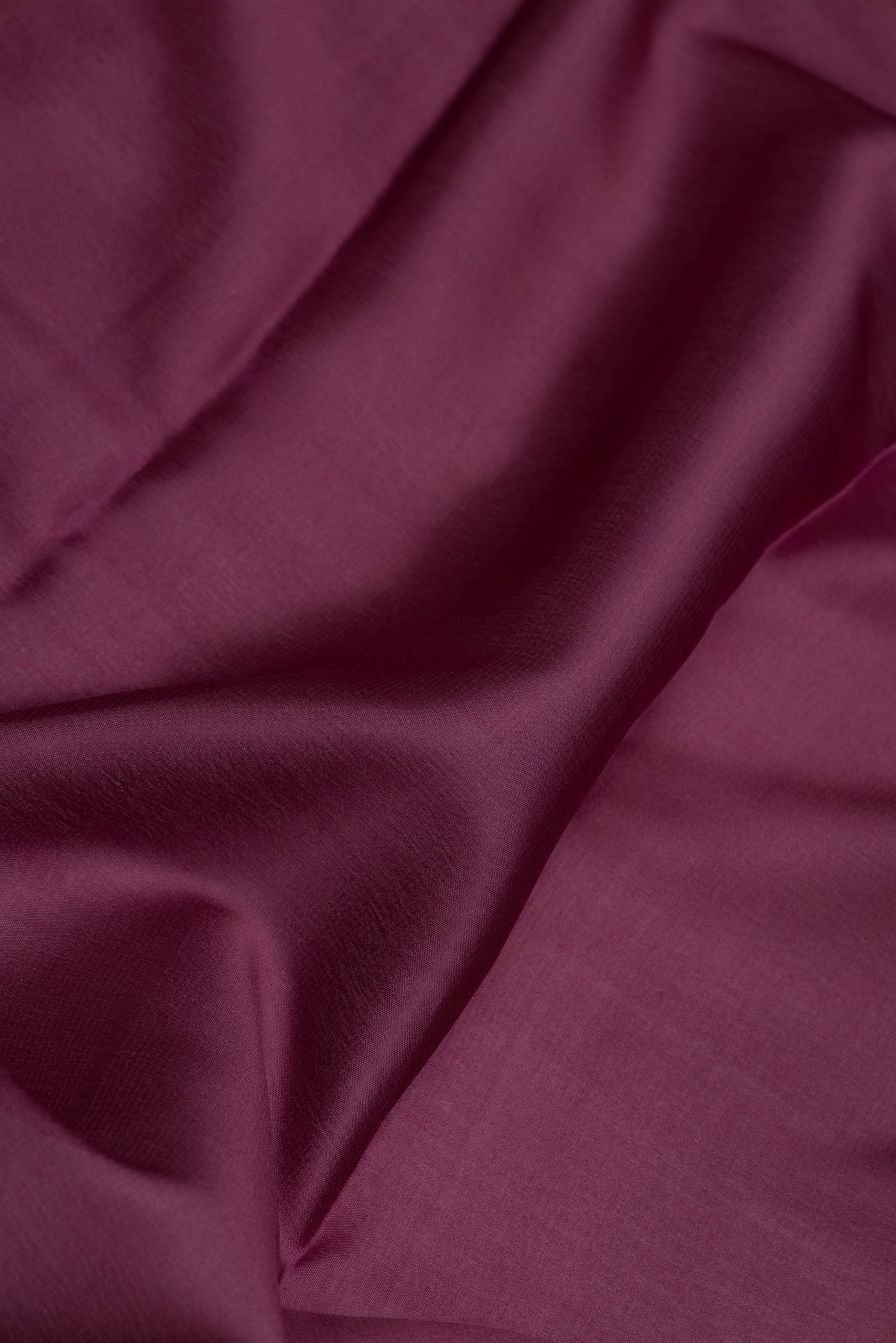 Close up of Burgundy Dual Tone Mysore Silk Saree with Plain Body and Zari Border.  displaying folds