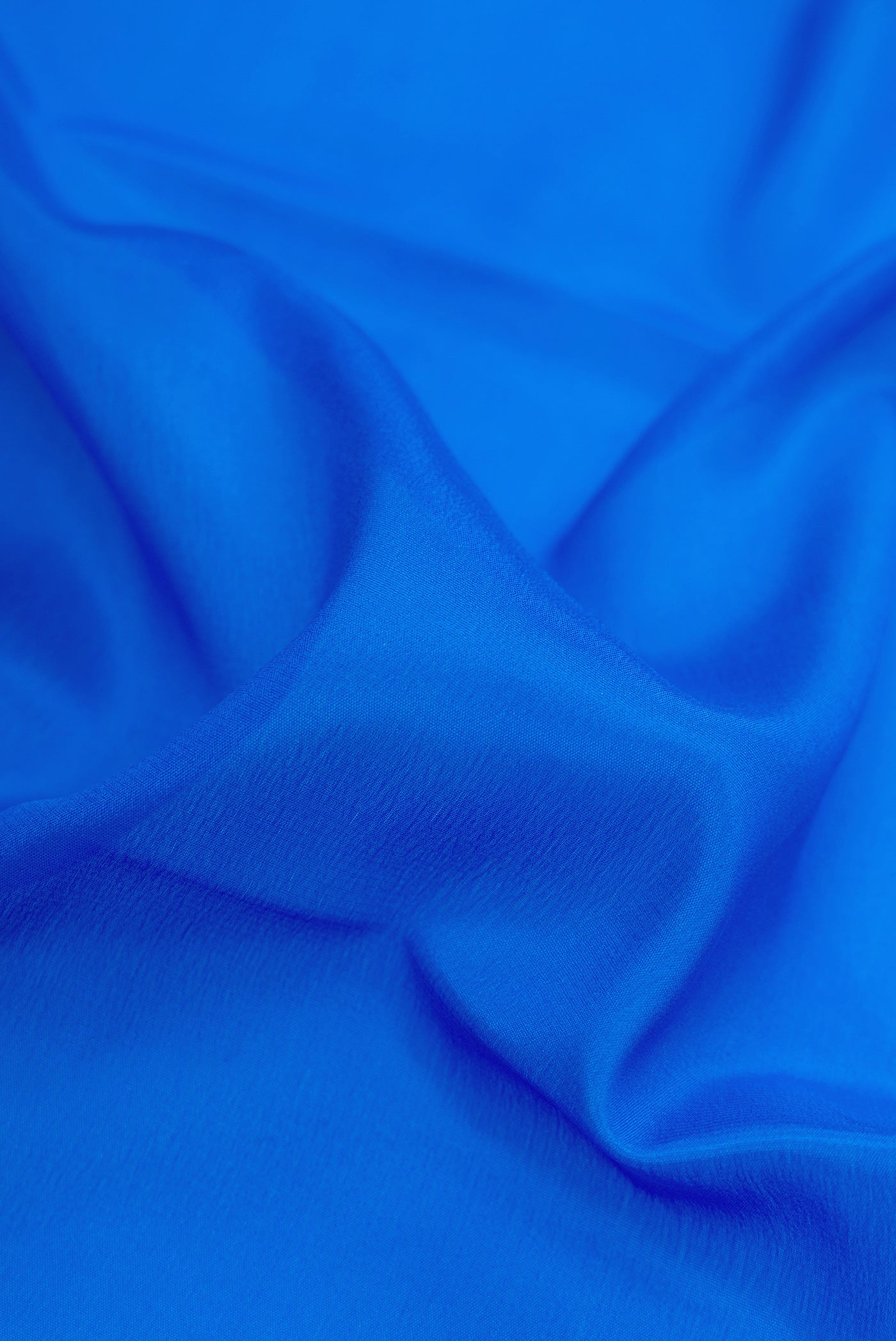 Close up of Royal Blue Dual Tone Mysore Silk Saree with Plain Body and Zari Border.  displaying folds