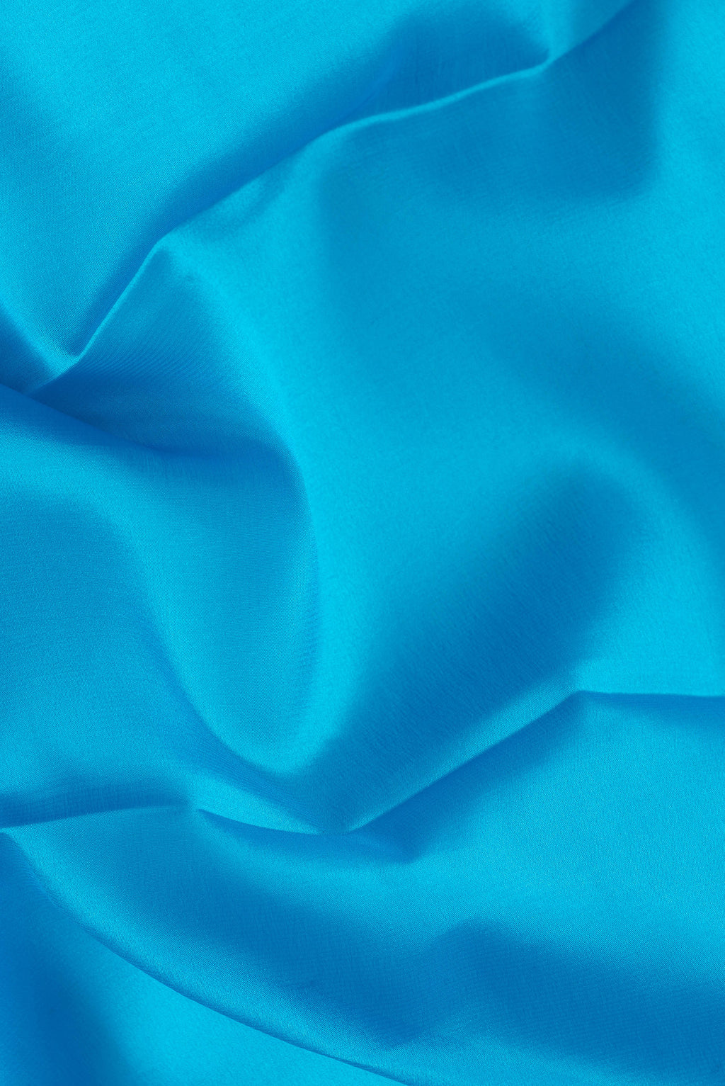 Close up of Sky Blue Dual Tone Mysore Silk Saree with Plain Body and Zari Border.  displaying folds