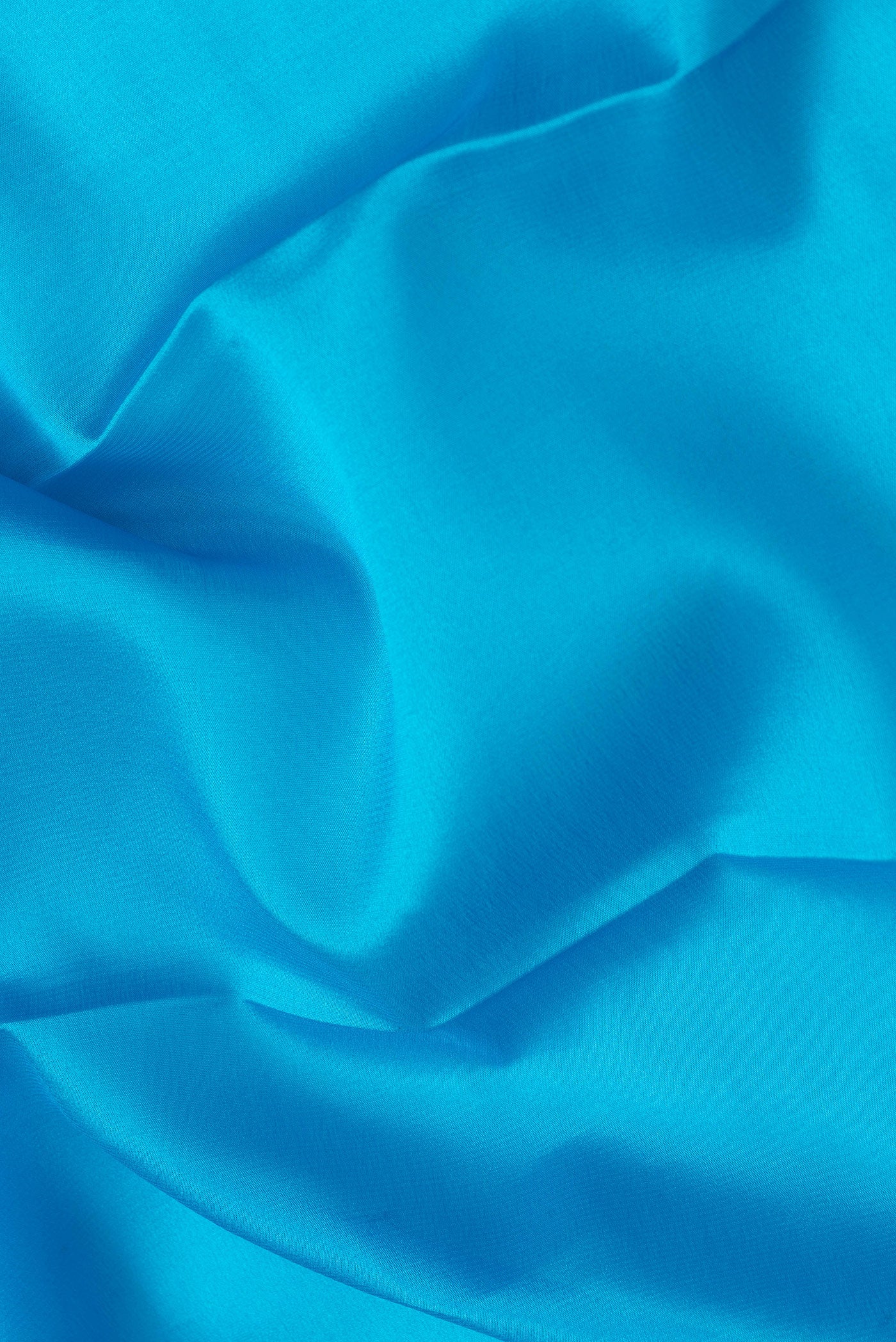 Close up of Sky Blue Dual Tone Mysore Silk Saree with Plain Body and Zari Border.  displaying folds