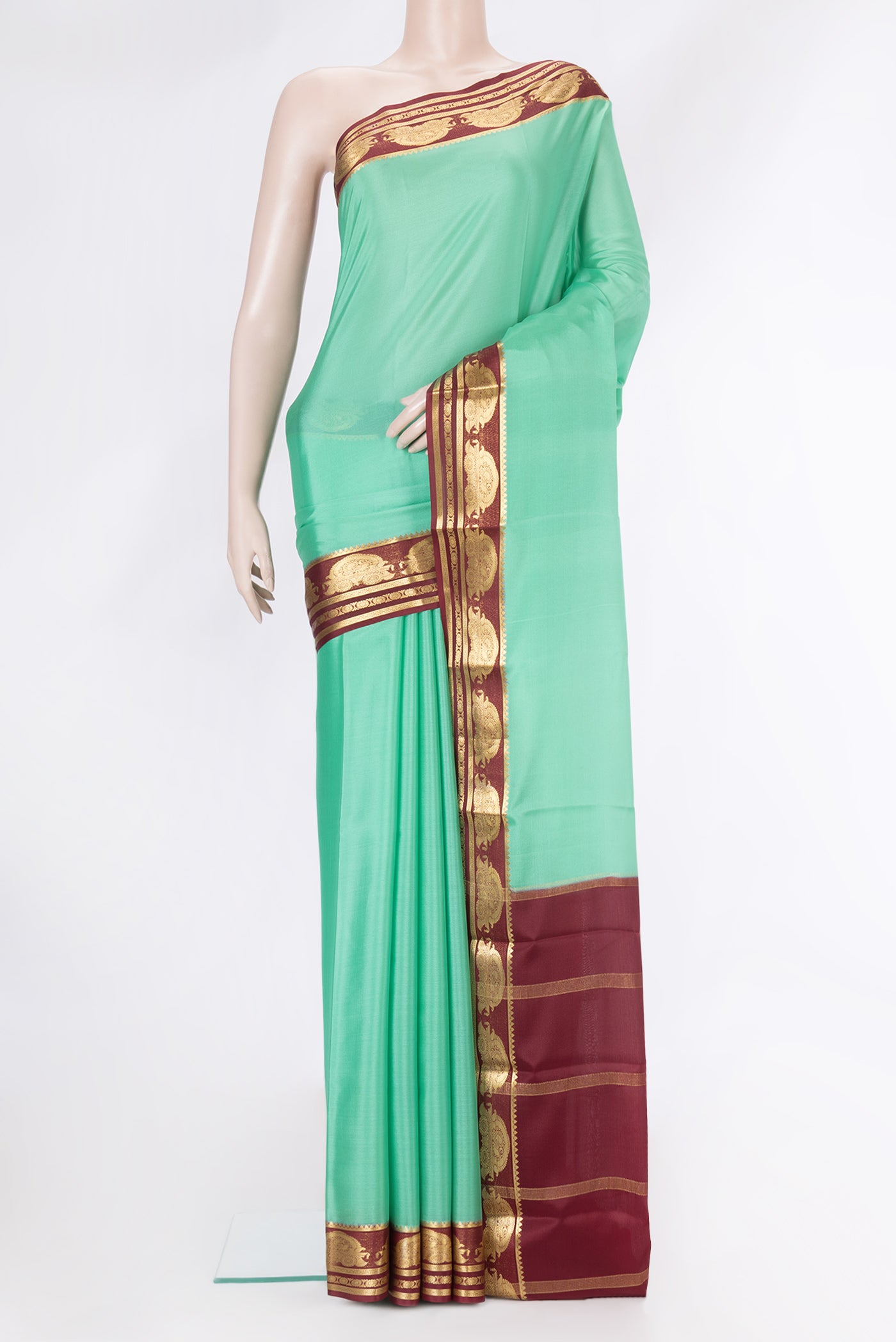 Light Green Dual Tone Mysore Silk Saree with Plain Body and Zari Border.  displayed on a mannequin
