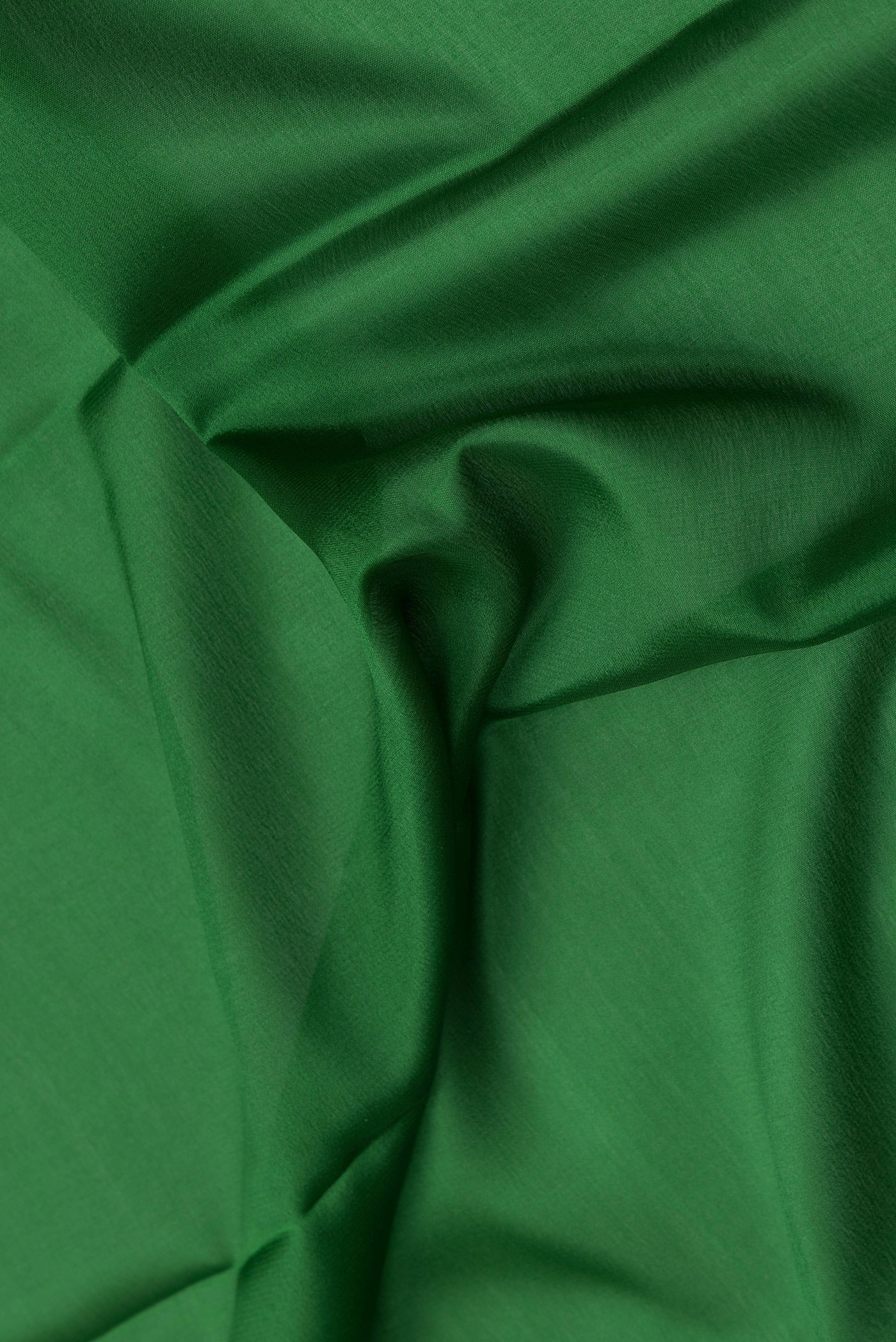 Close up of Green Dual Tone Mysore Crepe Saree with Plain Body and Zari Border.  displaying folds