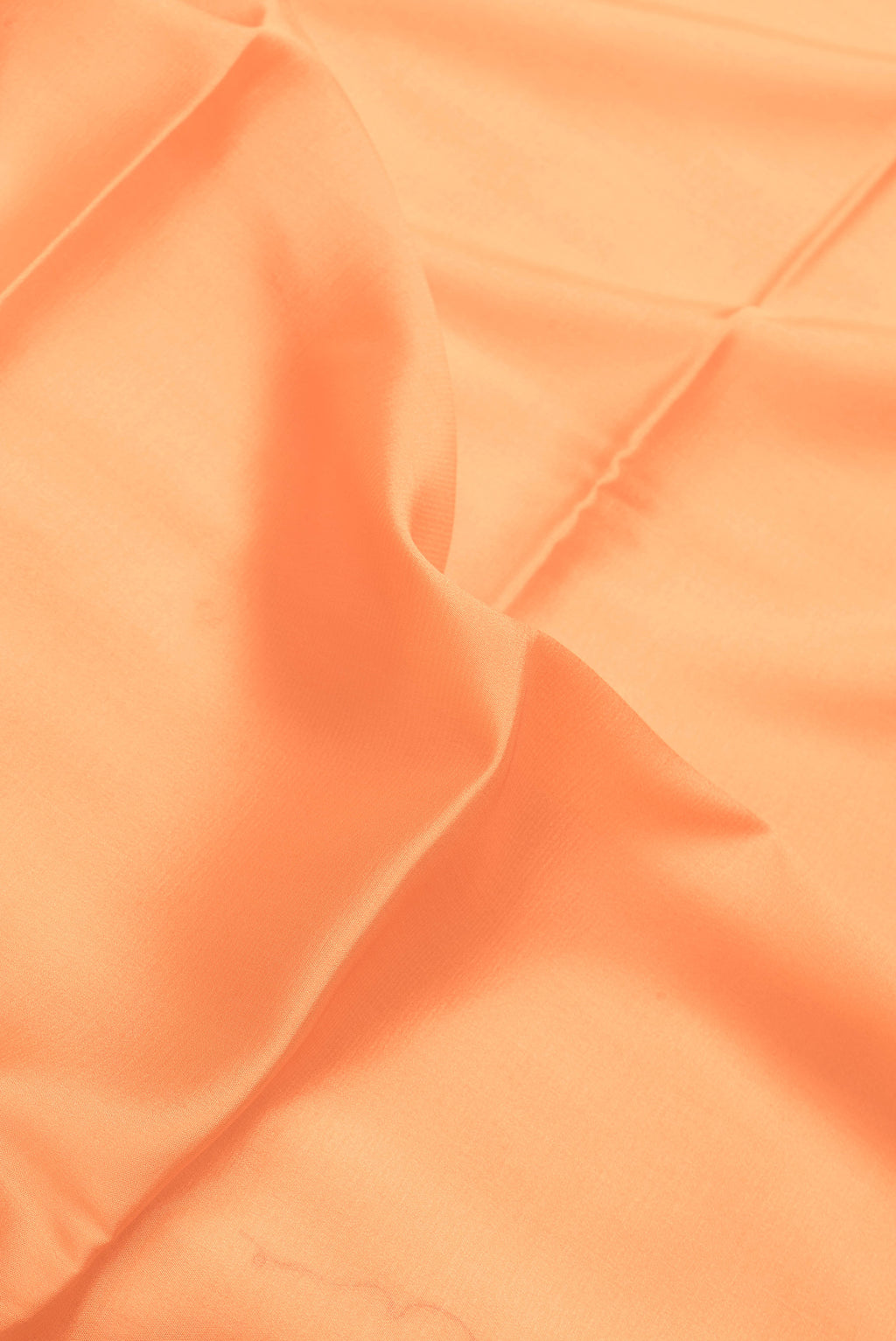 Close up of Peach Dual Tone Mysore Crepe Saree with Plain Body and Zari Border.  displaying folds